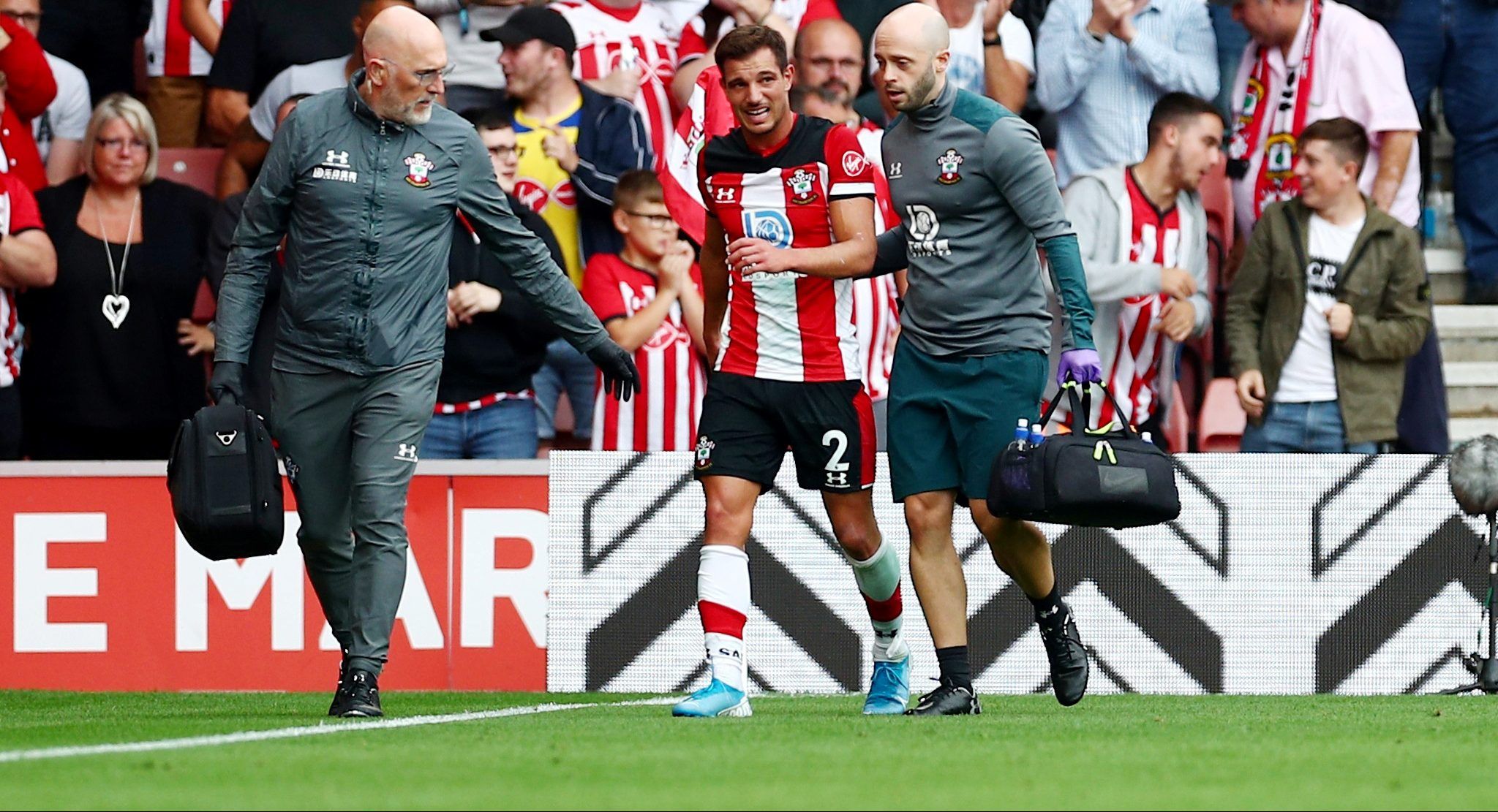 Soccer Football - Premier League - Southampton v Manchester United - St Mary's Stadium, Southampton, Britain - August 31, 2019  Southampton's Cedric Soares receives medical attention after sustaining an injury   REUTERS/Hannah Mckay  EDITORIAL USE ONLY. No use with unauthorized audio, video, data, fixture lists, club/league logos or 