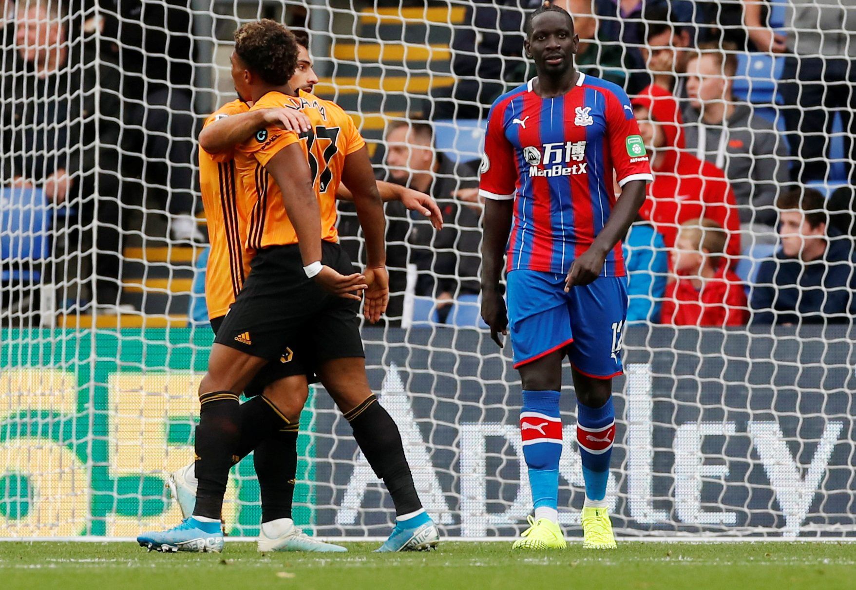 Soccer Football - Premier League - Crystal Palace v Wolverhampton Wanderers - Selhurst Park, London, Britain - September 22, 2019  Crystal Palace's Mamadou Sakho looks dejected as Wolverhampton Wanderers' Adama Traore and Jonny celebrate after Diogo Jota scored their first goal  Action Images via Reuters/Andrew Boyers  EDITORIAL USE ONLY. No use with unauthorized audio, video, data, fixture lists, club/league logos or 