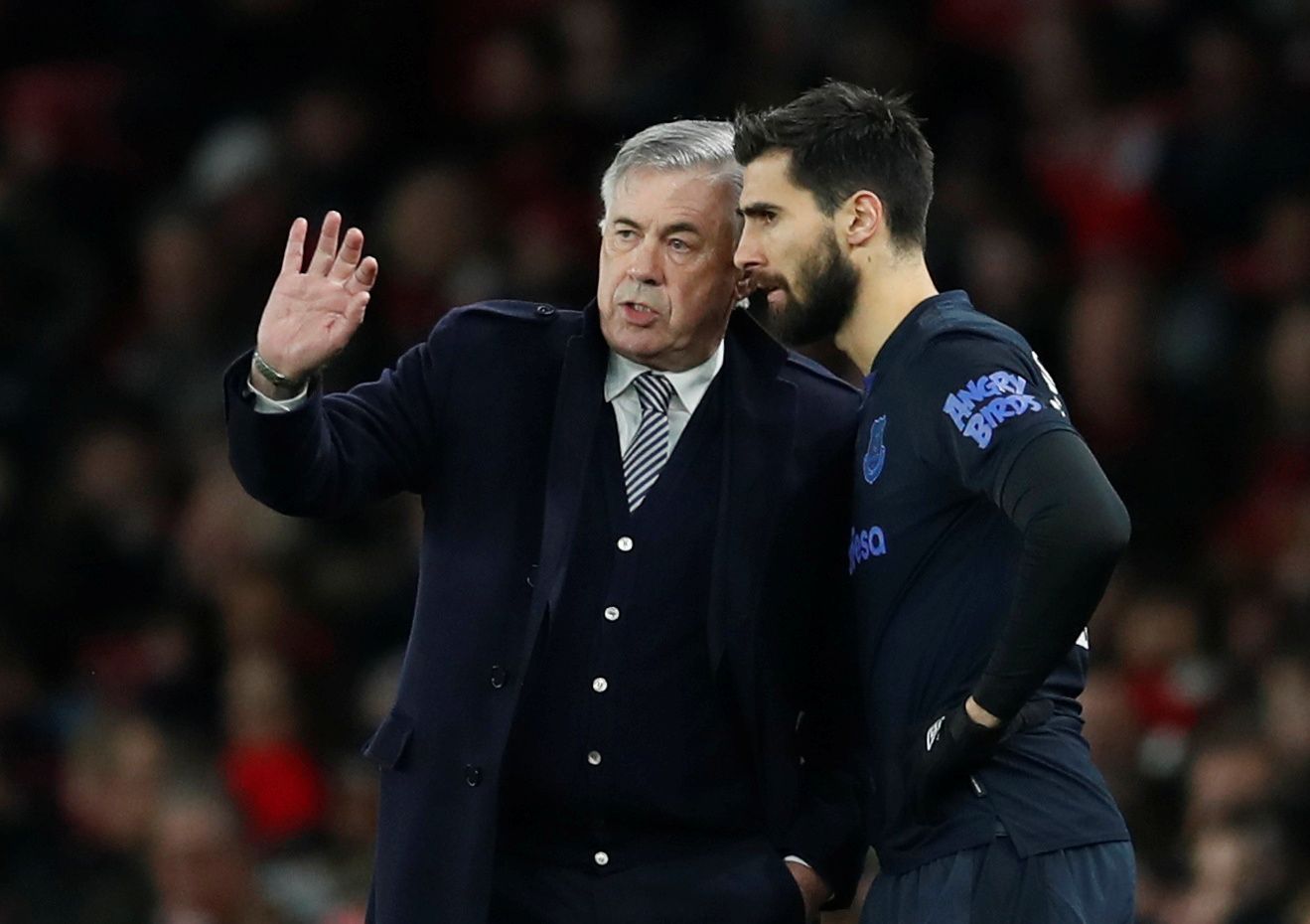 Soccer Football - Premier League - Arsenal v Everton - Emirates Stadium, London, Britain - February 23, 2020  Everton's Andre Gomes receives instructions from manager Carlo Ancelotti before being substituted on REUTERS/David Klein  EDITORIAL USE ONLY. No use with unauthorized audio, video, data, fixture lists, club/league logos or "live" services. Online in-match use limited to 75 images, no video emulation. No use in betting, games or single club/league/player publications.  Please contact your