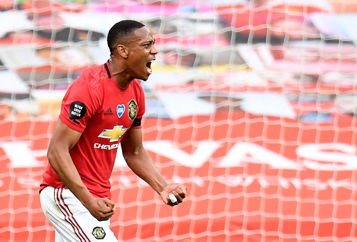 Soccer Football - Premier League - Manchester United v Southampton - Old Trafford, Manchester, Britain - July 13, 2020 Manchester United's  Anthony Martial celebrates scoring their second goal, as play resumes behind closed doors following the outbreak of the coronavirus disease (COVID-19) Pool via REUTERS/Peter Powell EDITORIAL USE ONLY. No use with unauthorized audio, video, data, fixture lists, club/league logos or 'live' services. Online in-match use limited to 75 images, no video emulation.