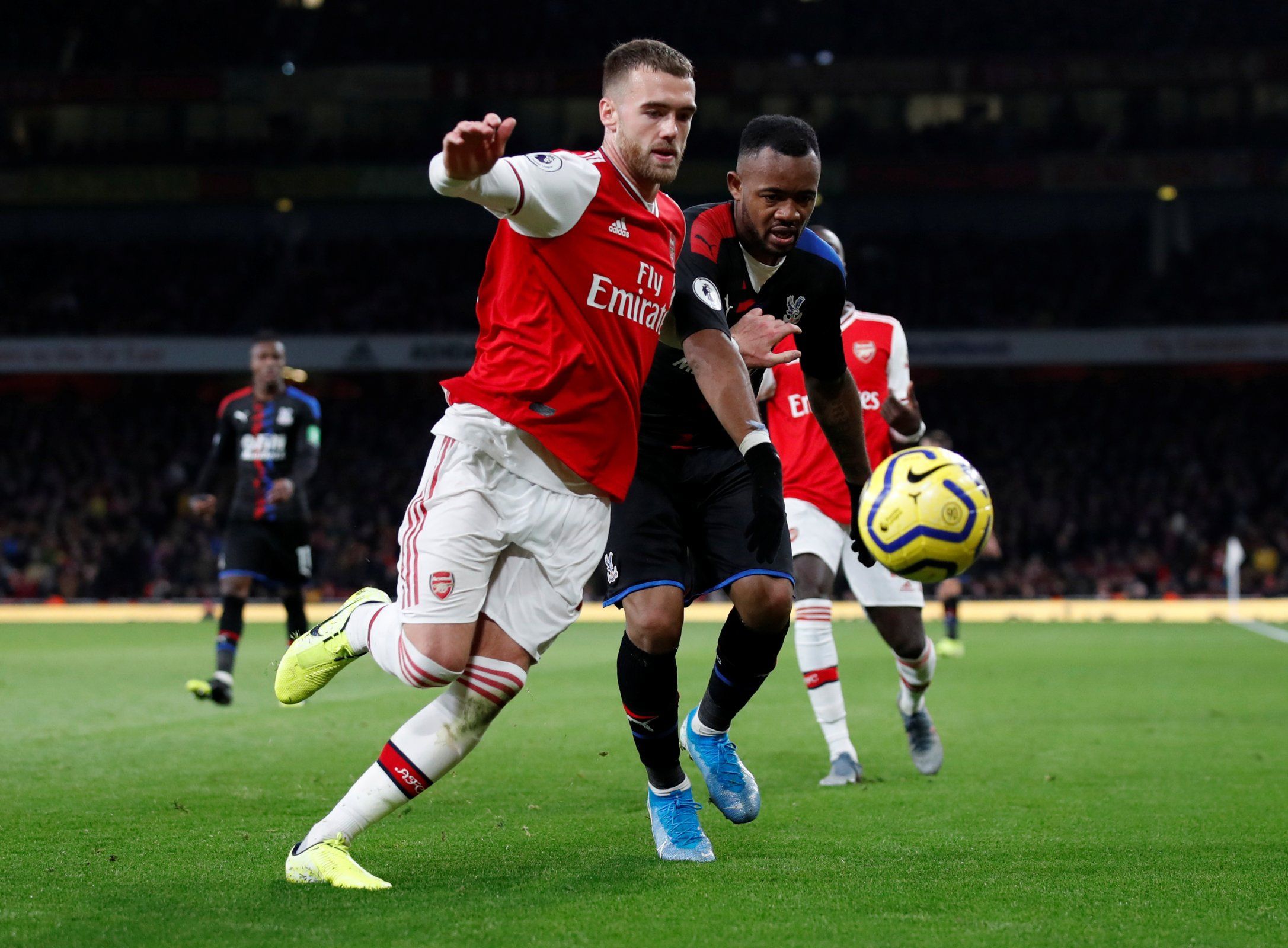 Arsenal's Calum Chambers in action with Crystal Palace's Jordan Ayew