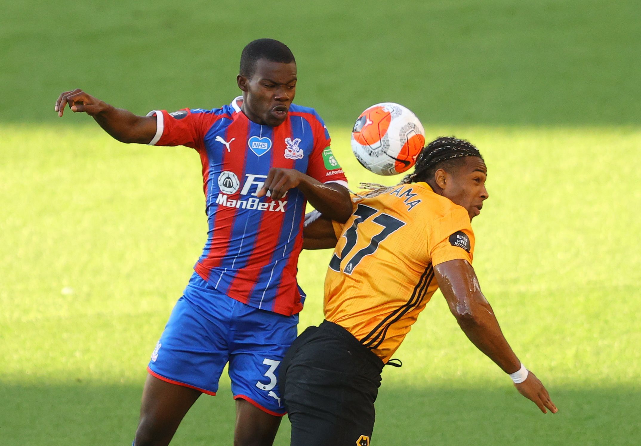 Soccer Football - Premier League - Wolverhampton Wanderers v Crystal Palace - Molineux Stadium, Wolverhampton, Britain - July 20, 2020 Crystal Palace's Tyrick Mitchell in action with Wolverhampton Wanderers' Adama Traore, as play resumes behind closed doors following the outbreak of the coronavirus disease (COVID-19) Pool via REUTERS/Richard Heathcote EDITORIAL USE ONLY. No use with unauthorized audio, video, data, fixture lists, club/league logos or 'live' services. Online in-match use limited 