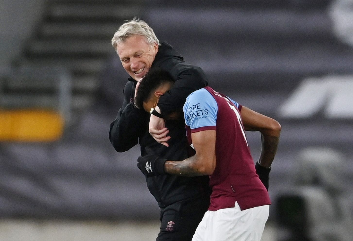 Soccer Football - Premier League - Wolverhampton Wanderers v West Ham United - Molineux Stadium, Wolverhampton, Britain - April 5, 2021 West Ham United's Jesse Lingard celebrates with manager David Moyes after the match Pool via REUTERS/Laurence Griffiths EDITORIAL USE ONLY. No use with unauthorized audio, video, data, fixture lists, club/league logos or 'live' services. Online in-match use limited to 75 images, no video emulation. No use in betting, games or single club /league/player publicati