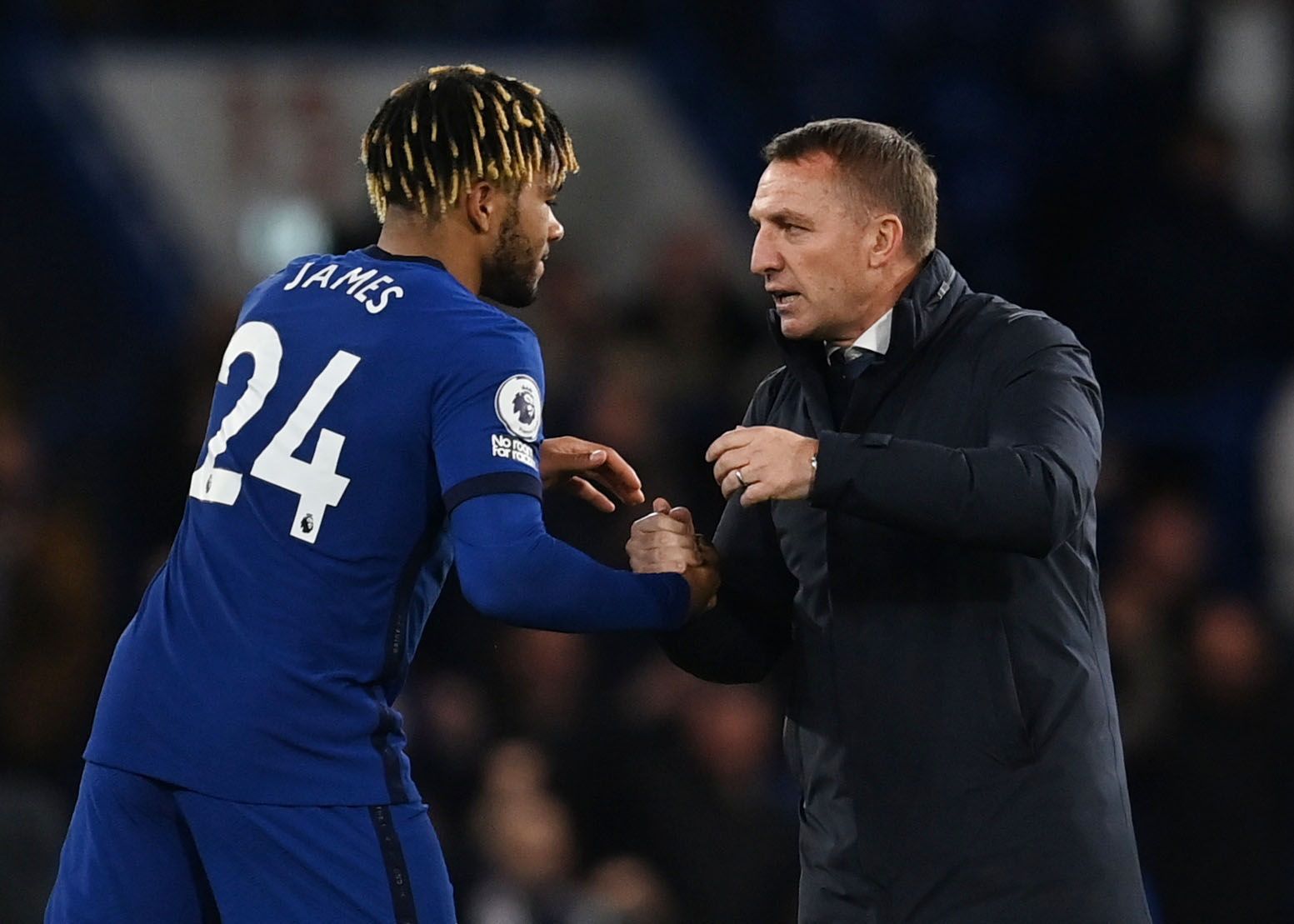 Soccer Football - Premier League - Chelsea v Leicester City - Stamford Bridge, London, Britain - May 18, 2021 Leicester City manager Brendan Rodgers shakes hands with Chelsea's Reece James after the match Pool via REUTERS/Glyn Kirk EDITORIAL USE ONLY. No use with unauthorized audio, video, data, fixture lists, club/league logos or 'live' services. Online in-match use limited to 75 images, no video emulation. No use in betting, games or single club /league/player publications.  Please contact you
