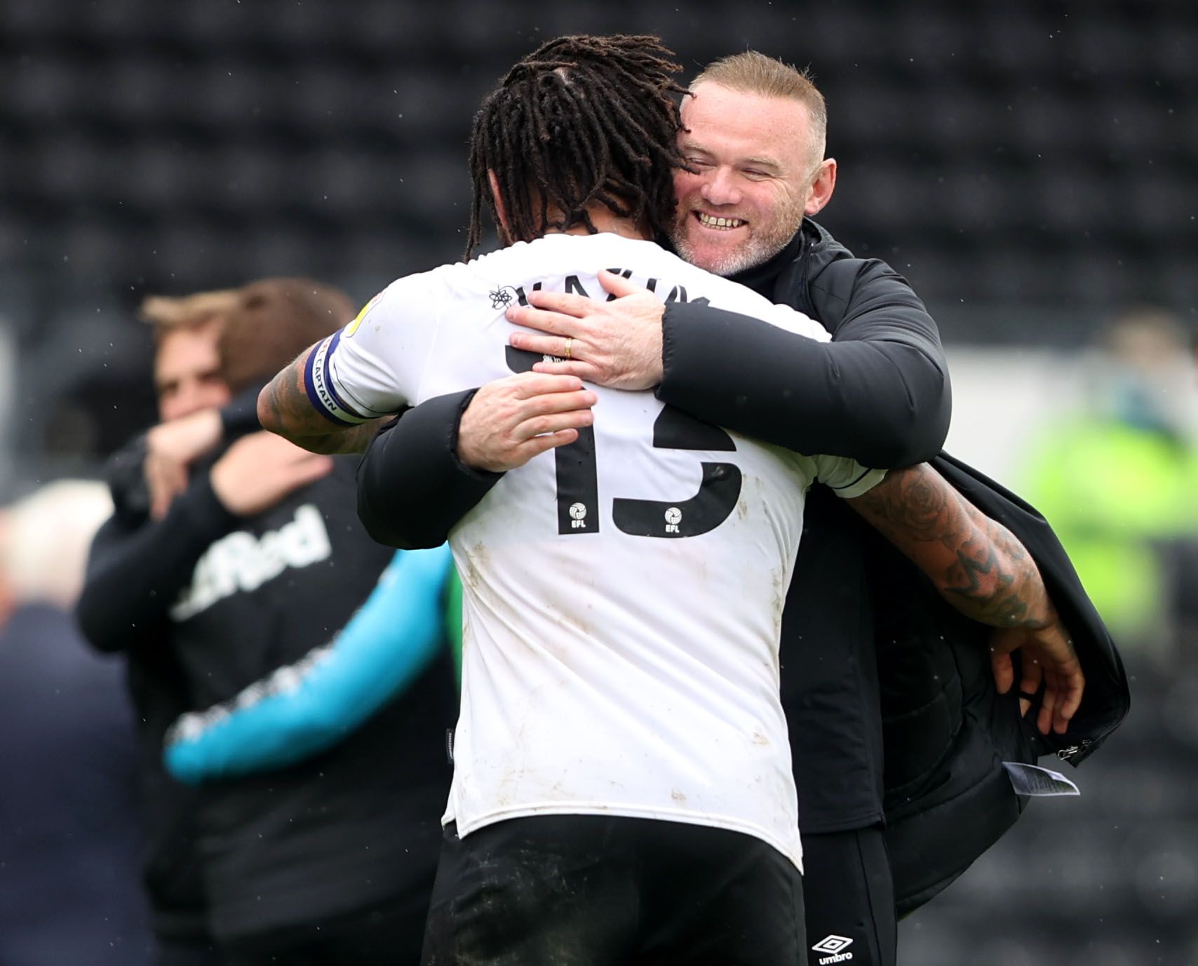 Soccer Football - Championship - Derby County v Sheffield Wednesday - Pride Park, Derby, Britain - May 8, 2021 Derby County manager Wayne Rooney celebrates after the match with Colin Kazim-Richards Action Images via Reuters/Molly Darlington EDITORIAL USE ONLY. No use with unauthorized audio, video, data, fixture lists, club/league logos or 'live' services. Online in-match use limited to 75 images, no video emulation. No use in betting, games or single club /league/player publications.  Please co