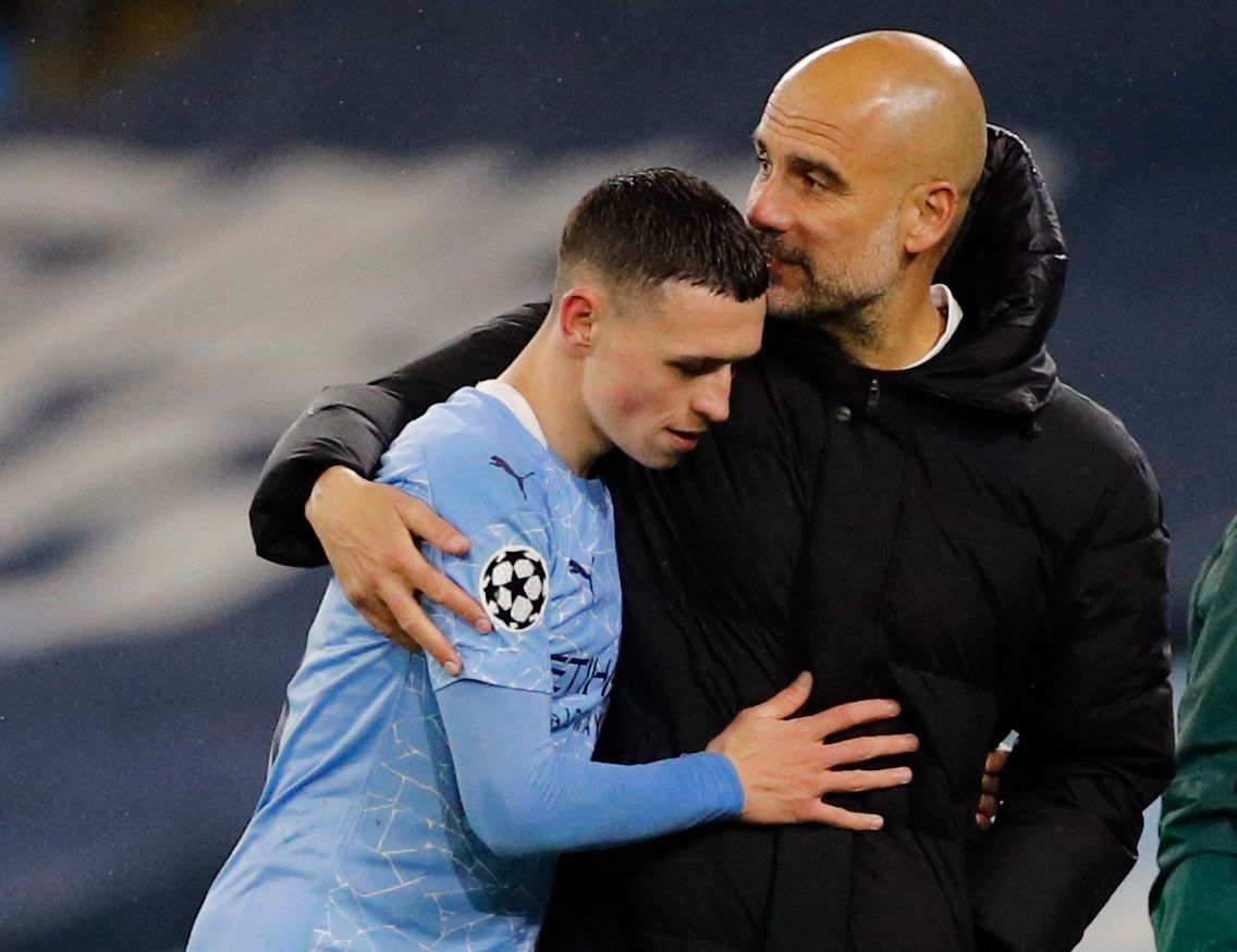 Soccer Football - Champions League - Semi Final Second Leg - Manchester City v Paris St Germain - Etihad Stadium, Manchester, Britain - May 4, 2021 Manchester City manager Pep Guardiola with Phil Foden as he is substituted REUTERS/Phil Noble