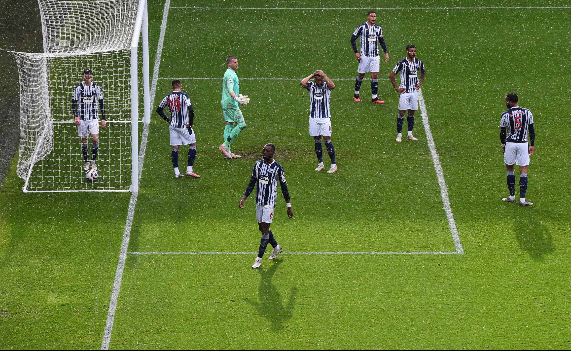 dejected west brom players react after alisson heads home winner