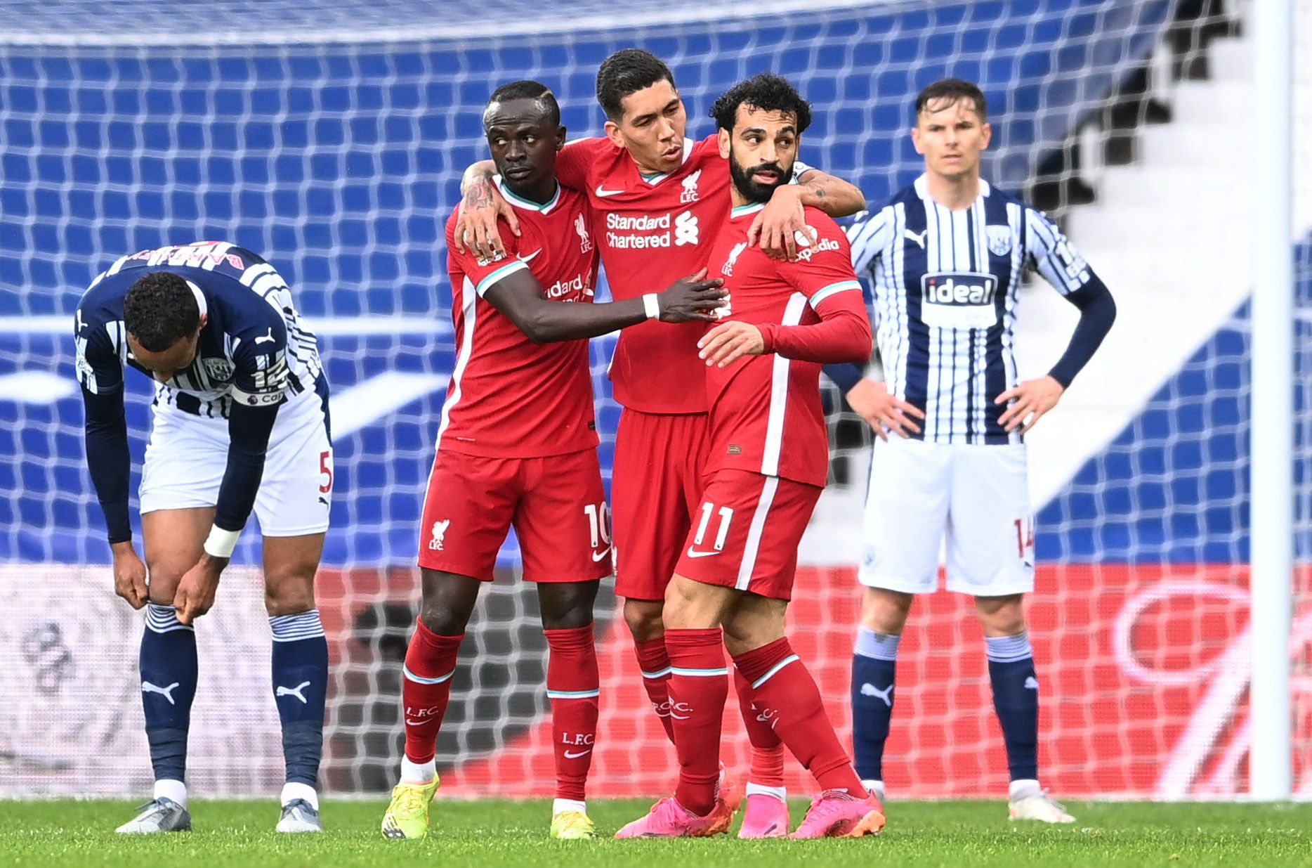 Soccer Football - Premier League - West Bromwich Albion v Liverpool - The Hawthorns, West Bromwich, Britain - May 16, 2021 Liverpool's Mohamed Salah celebrates scoring their first goal with Sadio Mane and Roberto Firmino Pool via REUTERS/Laurence Griffiths EDITORIAL USE ONLY. No use with unauthorized audio, video, data, fixture lists, club/league logos or 'live' services. Online in-match use limited to 75 images, no video emulation. No use in betting, games or single club /league/player publicat