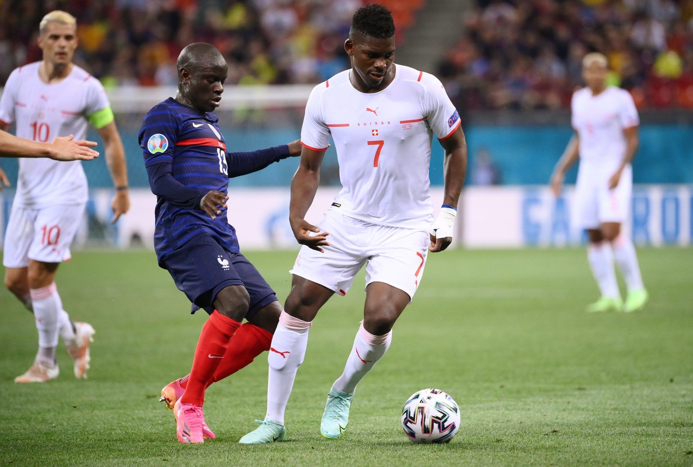 switzerland attacker breel embolo in action with chelsea midfielder ngolo kante at euro 2020 round of 16 clash