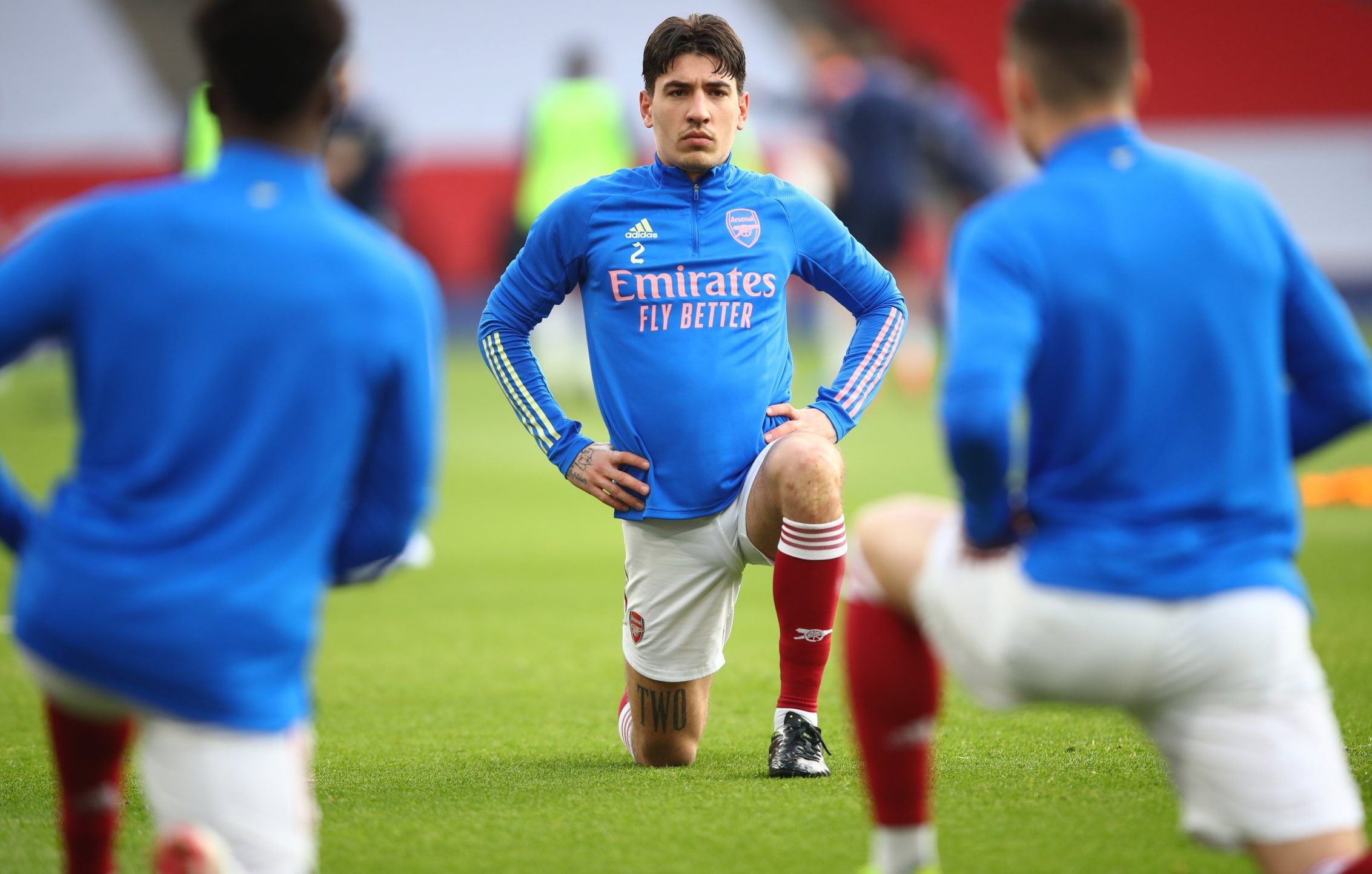 Arsenal right-back Hector Bellerin stretches during warm-up before Mnachester City clash at the Emirates Stadium