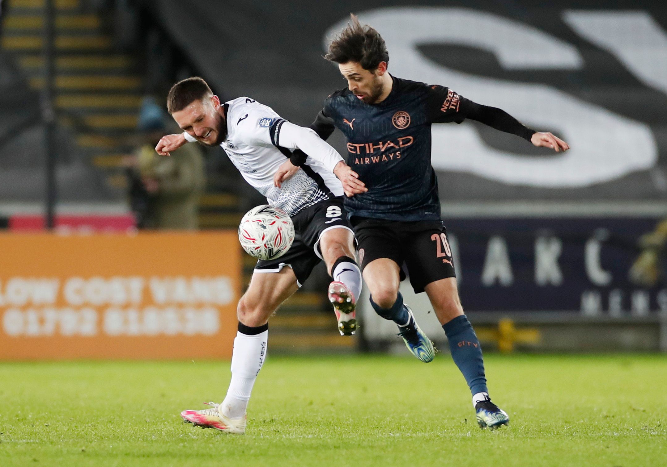 Soccer Football -  FA Cup - Fifth Round - Swansea City v Manchester City - Liberty Stadium, Swansea, Wales, Britain - February 10, 2021   Swansea City's Matt Grimes in action with Manchester City's Bernardo Silva Action Images via Reuters/Paul Childs