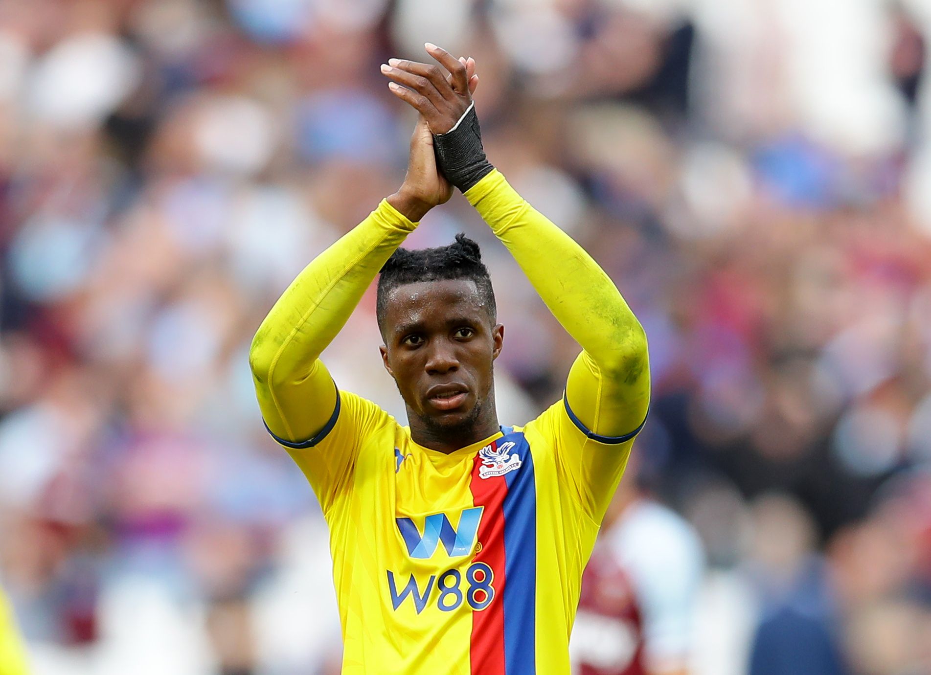Soccer Football - Premier League - West Ham United v Crystal Palace - London Stadium, London, Britain - August 28, 2021 Crystal Palace's Wilfried Zaha applauds fans after the match REUTERS/David Klein EDITORIAL USE ONLY. No use with unauthorized audio, video, data, fixture lists, club/league logos or 'live' services. Online in-match use limited to 75 images, no video emulation. No use in betting, games or single club /league/player publications.  Please contact your account representative for fu