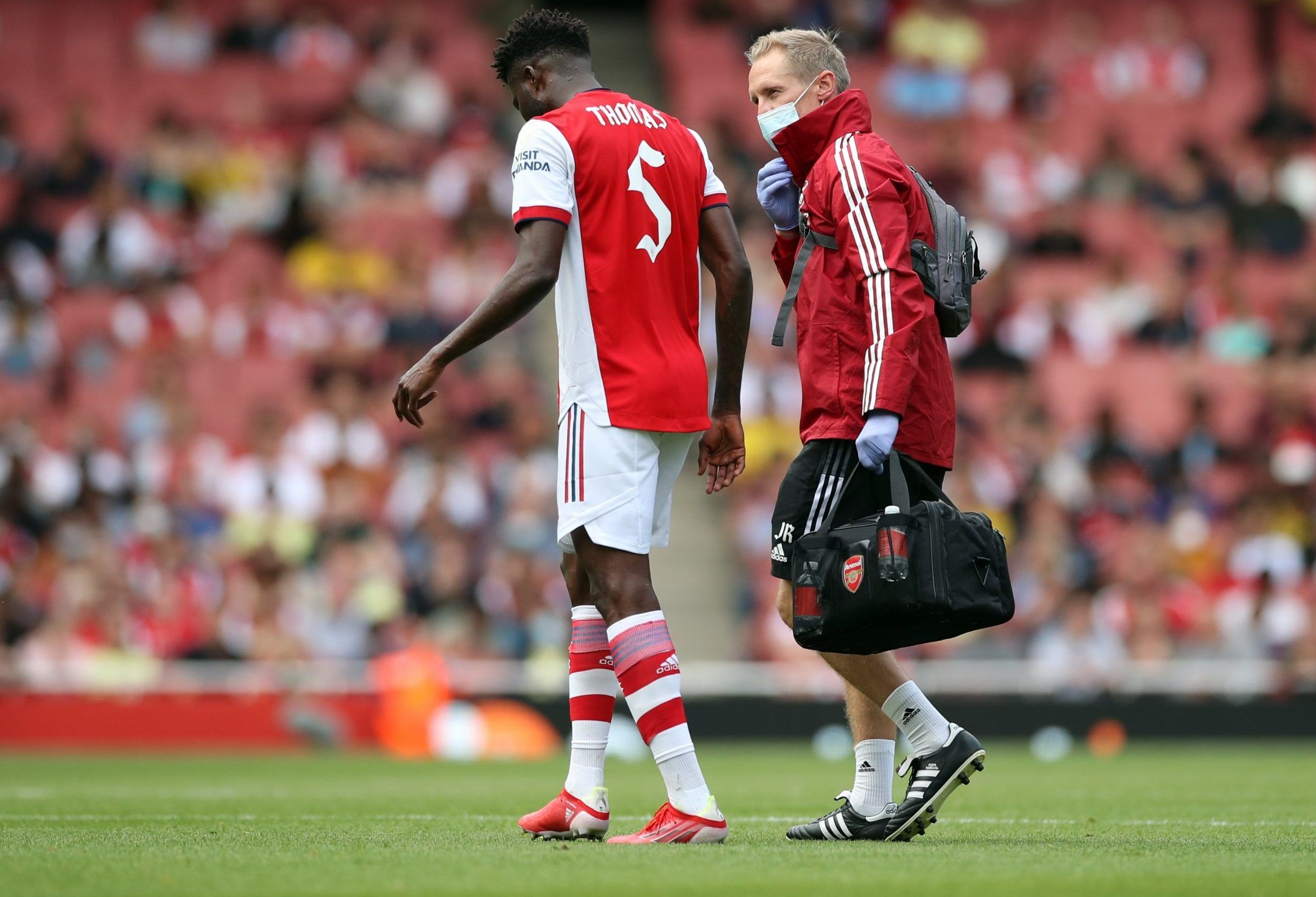 Arsenal midfielder Thomas Partey walks off injured during pre-season clash with Chelsea at the Emirates Stadium