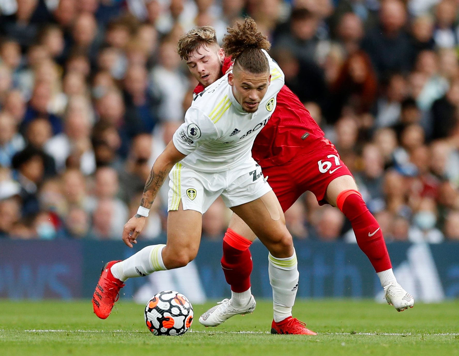 Soccer Football - Premier League - Leeds United v Liverpool - Elland Road, Leeds, Britain - September 12, 2021 Leeds United's Kalvin Phillips in action with Liverpool's Harvey Elliott Action Images via Reuters/Lee Smith EDITORIAL USE ONLY. No use with unauthorized audio, video, data, fixture lists, club/league logos or 'live' services. Online in-match use limited to 75 images, no video emulation. No use in betting, games or single club /league/player publications.  Please contact your account re