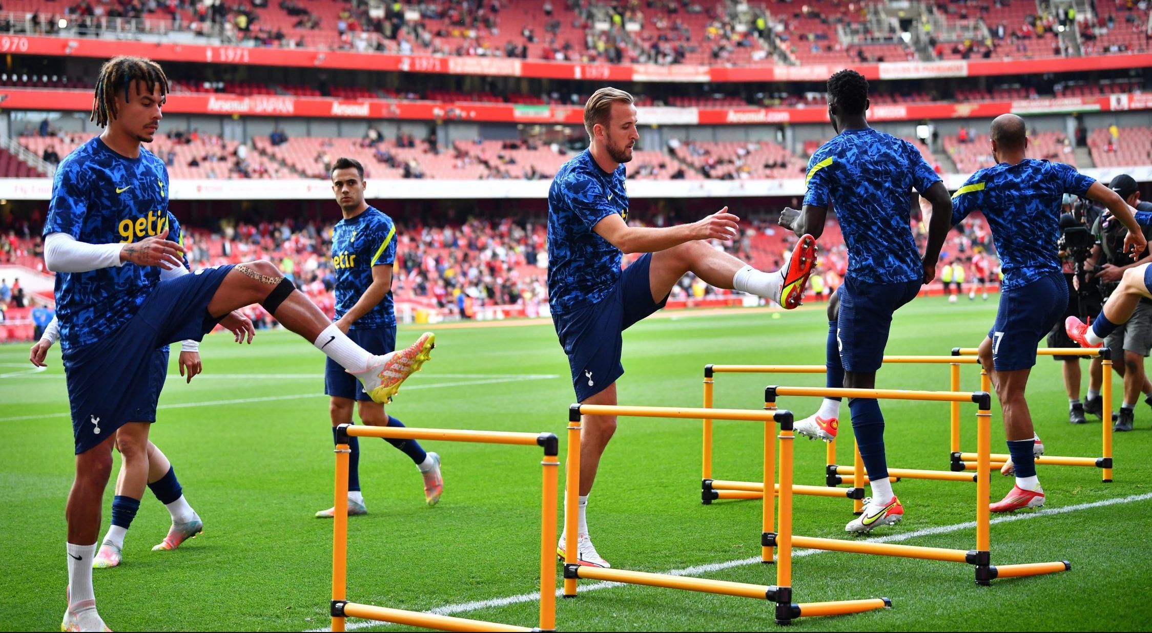 Spurs players warm up against Arsenal in the Premier League