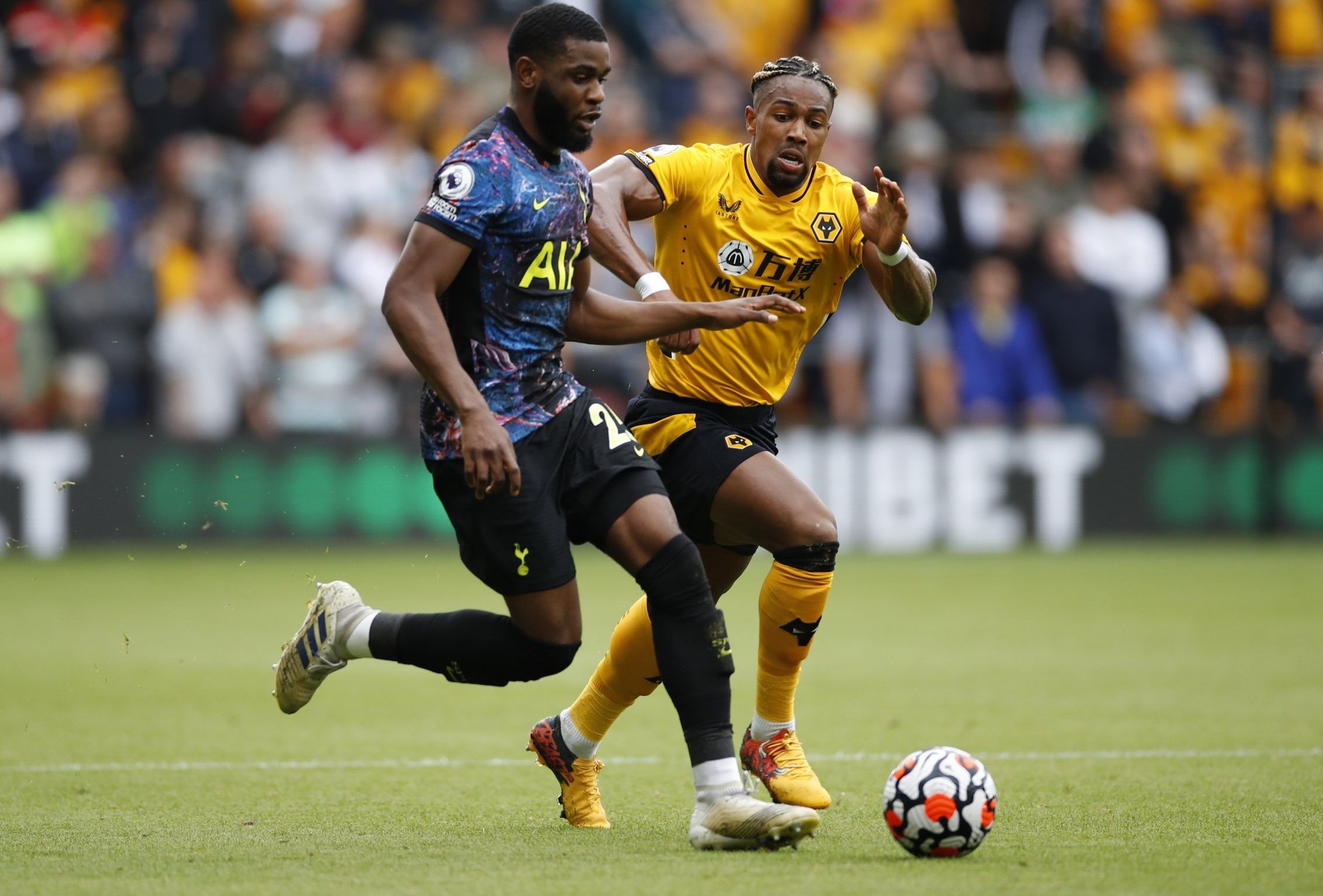 Tottenham Hotspur defender Japhet Tanganga on the ball against Wolves' Adama Traore in the Premier League