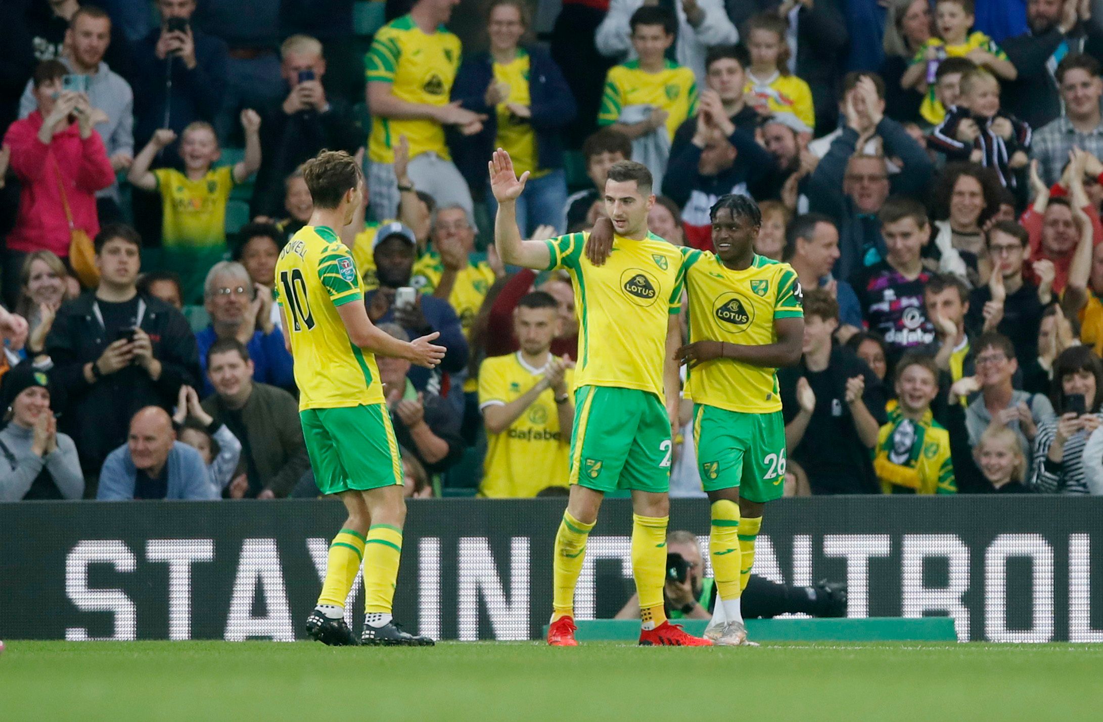 Soccer - England - Carabao Cup Second Round - Norwich City v AFC Bournemouth - Carrow Road, Norwich, Britain - August 24, 2021 Norwich City's Kenny McLean celebrates scoring their second goal with  Bali Mumba and  Kieran Dowell Action Images via Reuters/Matthew Childs