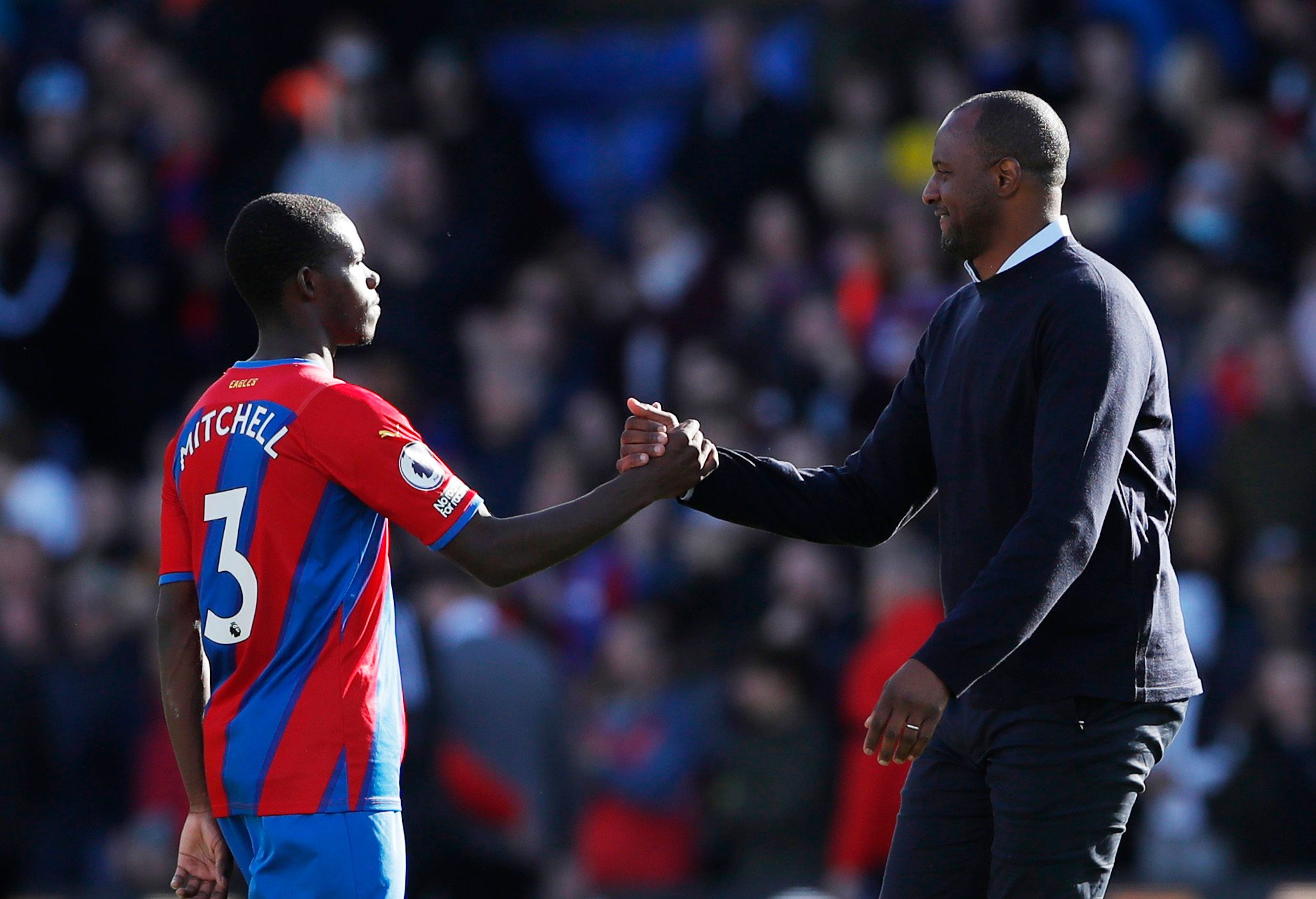 Soccer Football - Premier League - Crystal Palace v Leicester City - Selhurst Park, London, Britain - October 3, 2021 Crystal Palace's Tyrick Mitchell shakes hands with  manager Patrick Vieira after the match Action Images via Reuters/Andrew Couldridge EDITORIAL USE ONLY. No use with unauthorized audio, video, data, fixture lists, club/league logos or 'live' services. Online in-match use limited to 75 images, no video emulation. No use in betting, games or single club /league/player publications