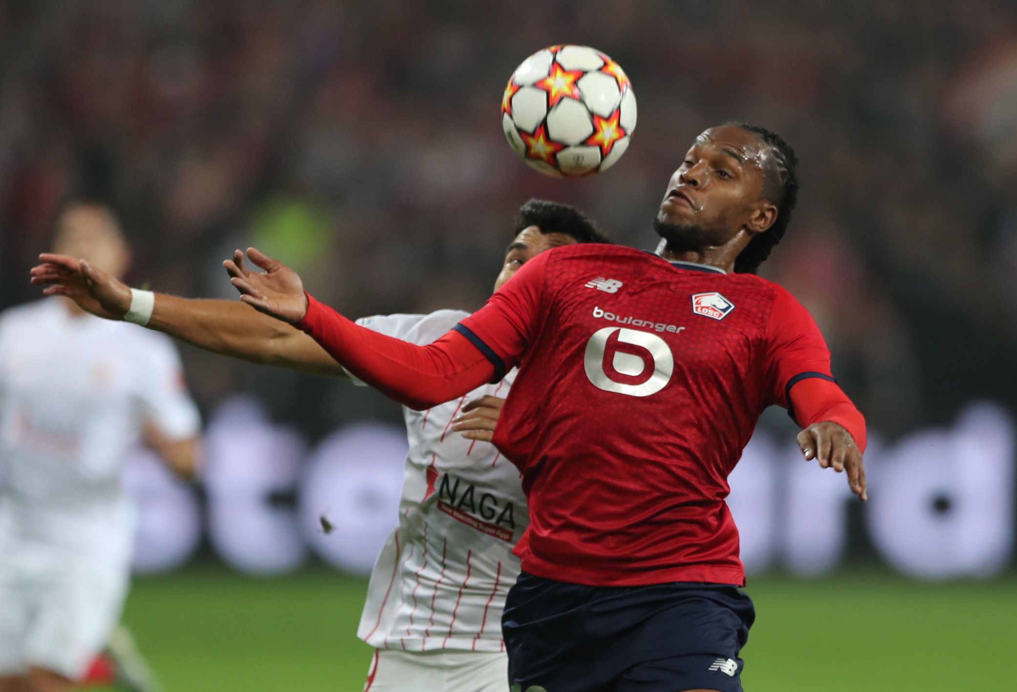 Soccer Football - Champions League - Group G - Lille v Sevilla - Stade Pierre-Mauroy, Lille, France - October 20, 2021 Lille's Renato Sanches in action with Sevilla's Marcos Acuna REUTERS/Pascal Rossignol