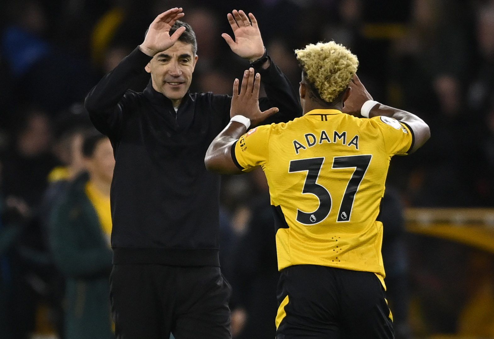 Soccer Football - Premier League - Wolverhampton Wanderers v West Ham United - Molineux Stadium, Wolverhampton, Britain - November 20, 2021  Wolverhampton Wanderers manager Bruno Lage celebrates with Adama Traore after the match REUTERS/Tony Obrien EDITORIAL USE ONLY. No use with unauthorized audio, video, data, fixture lists, club/league logos or 'live' services. Online in-match use limited to 75 images, no video emulation. No use in betting, games or single club /league/player publications.  P