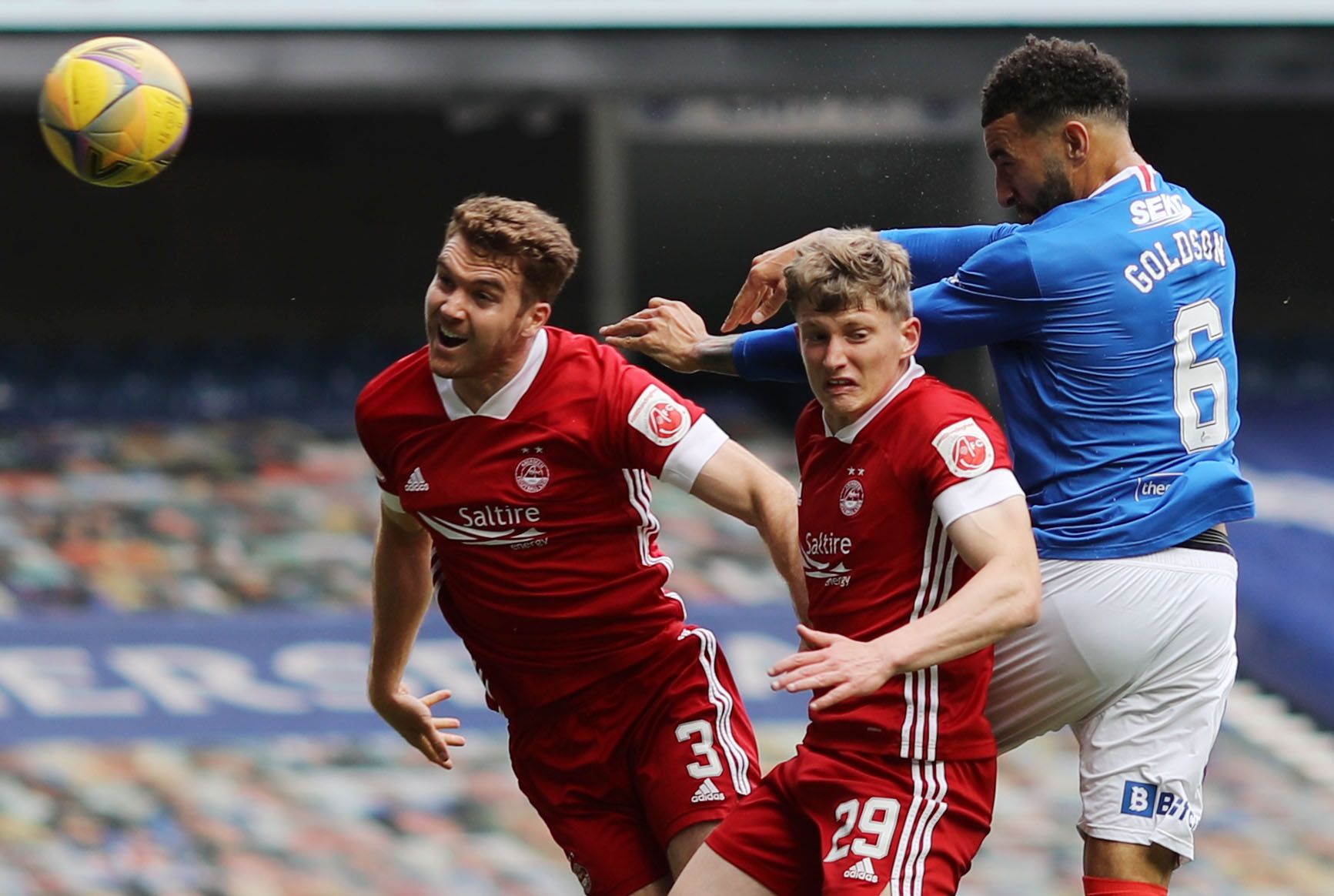Soccer Football - Scottish Premiership - Rangers v Aberdeen - Ibrox, Glasgow, Scotland, Britain - May 15, 2021 Rangers' Connor Goldson in action with Aberdeen's Jack Mackenzie and Tommie Hoban REUTERS/Russell Cheyne