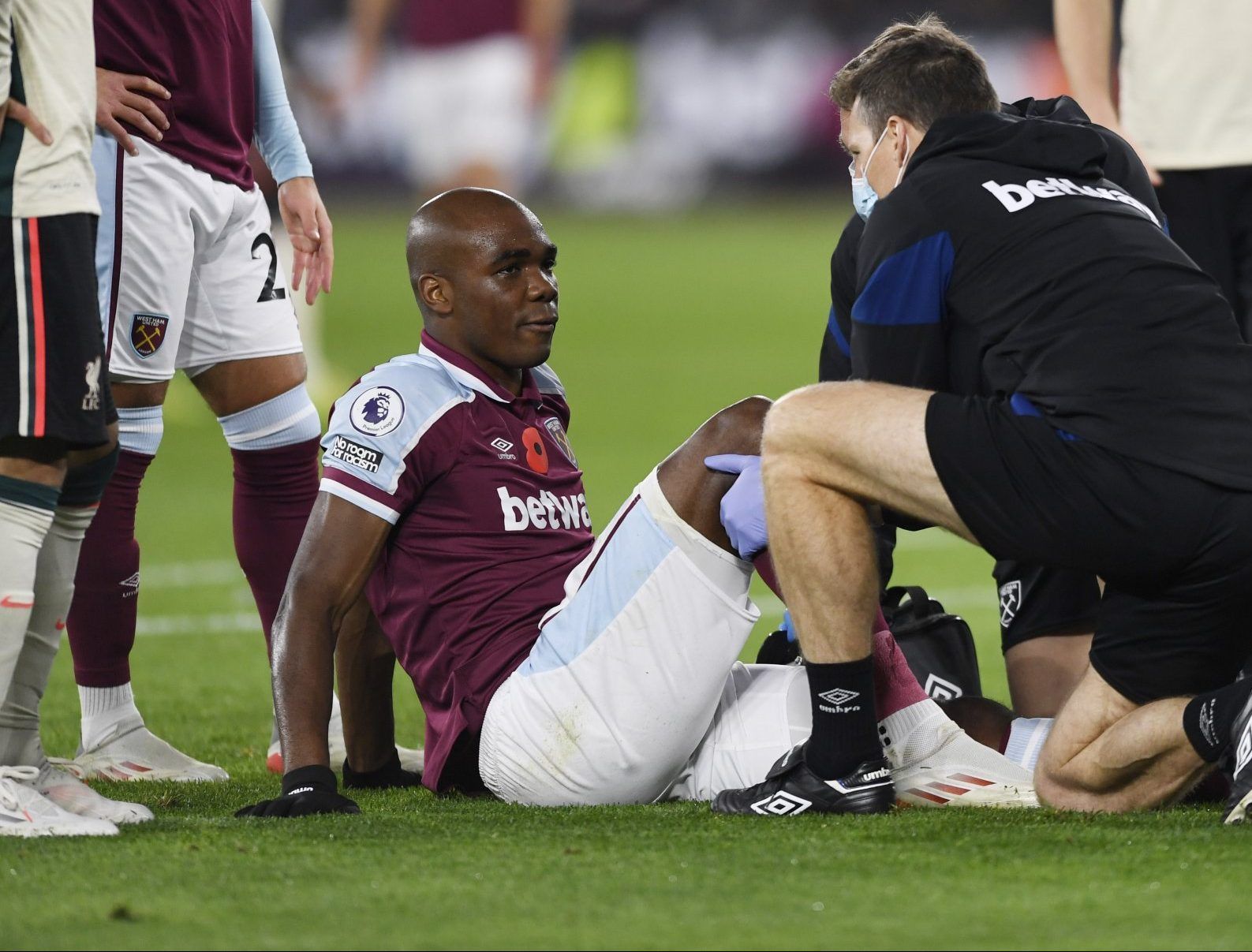 West Ham defender Angelo Ogbonna receives treatment after injury against Liverpool in the Premier League