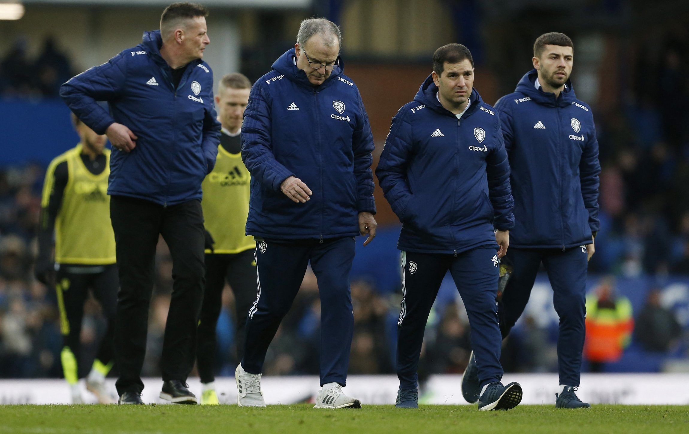 Leeds United boss Marcelo Bielsa and coaching staff walk off after defeat to Everton