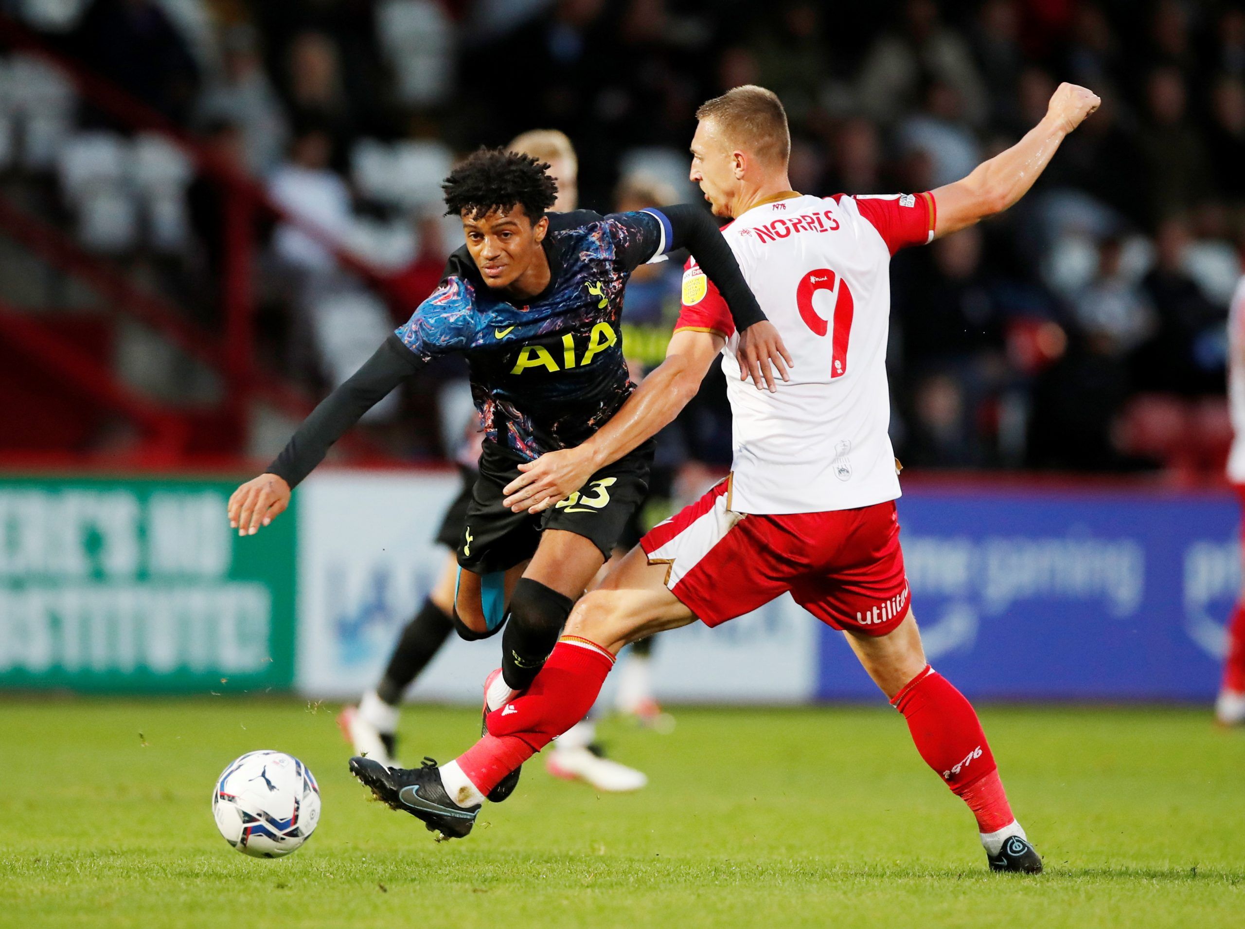 Soccer Football - EFL Trophy - Group Stage - Southern Group H - Stevenage v Tottenham Hotspur U21 - The Lamex Stadium, Stevenage, Britain - August 31, 2021  Stevenage's Luke Norris and Tottenham Hotspur's Brooklyn Lyons-Foster  Action Images/Paul Childs  EDITORIAL USE ONLY. No use with unauthorized audio, video, data, fixture lists, club/league logos or 