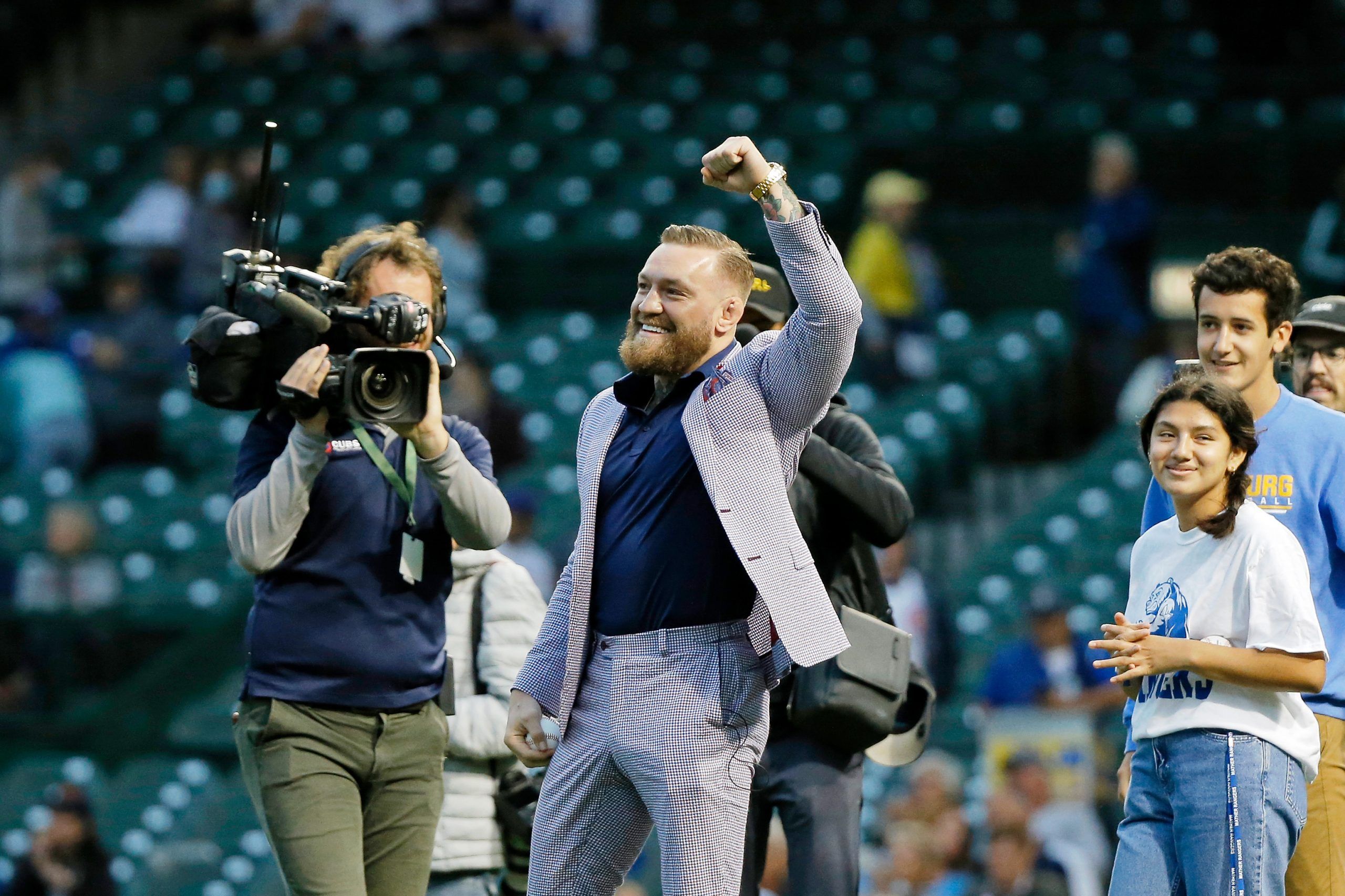 Sep 21, 2021; Chicago, Illinois, USA; MMA fighter Conor McGregor pumps his fist as he walks on the field before the game between the Chicago Cubs and the Minnesota Twins at Wrigley Field. Mandatory Credit: Jon Durr-USA TODAY Sports