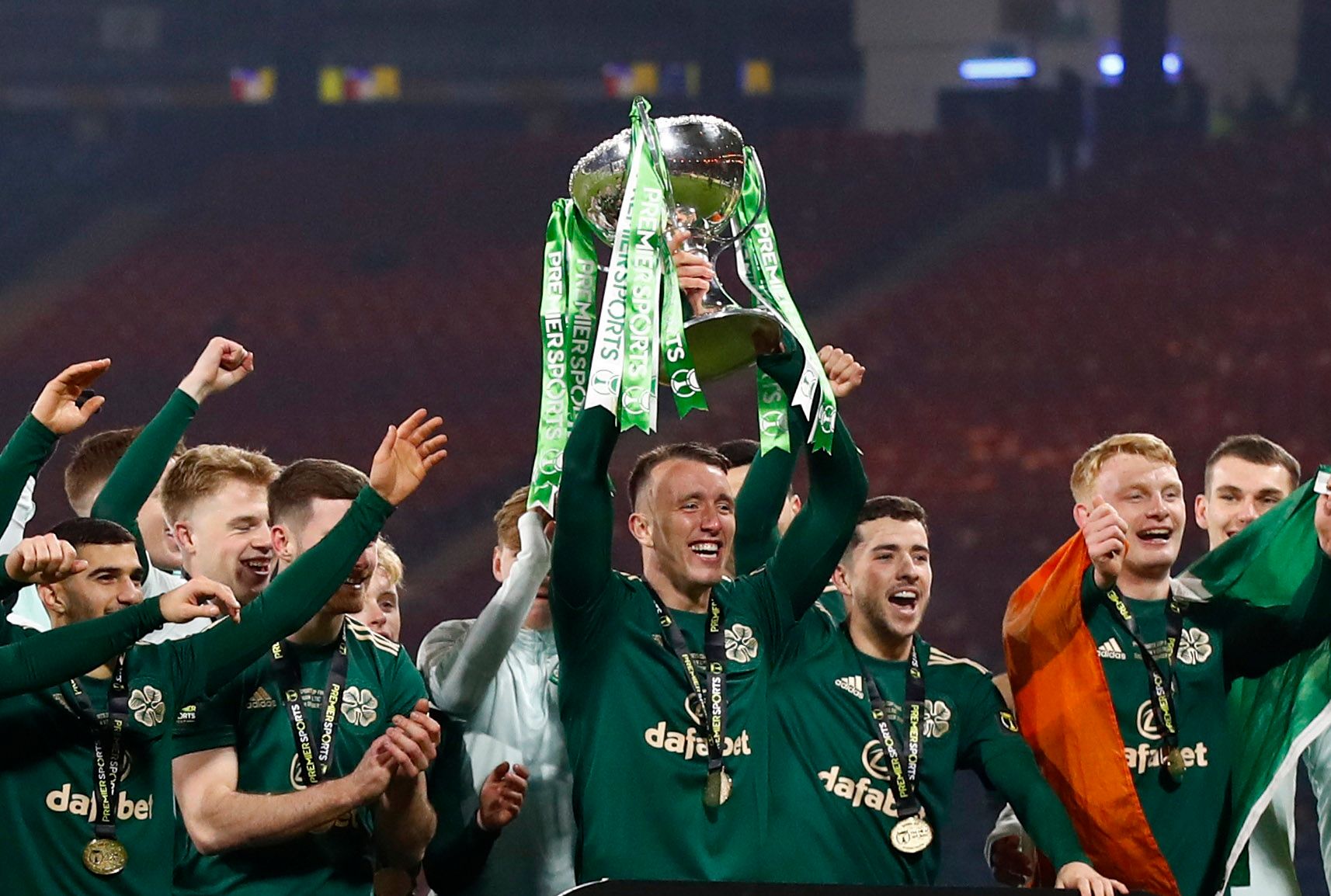 Soccer Football - Scottish League Cup Final - Hibernian v Celtic - Hampden Park, Glasgow, Scotland, Britain - December 19, 2021  Celtic's David Turnbull and teammates celebrate with the trophy after winning the league cup final Action Images via Reuters/Jason Cairnduff