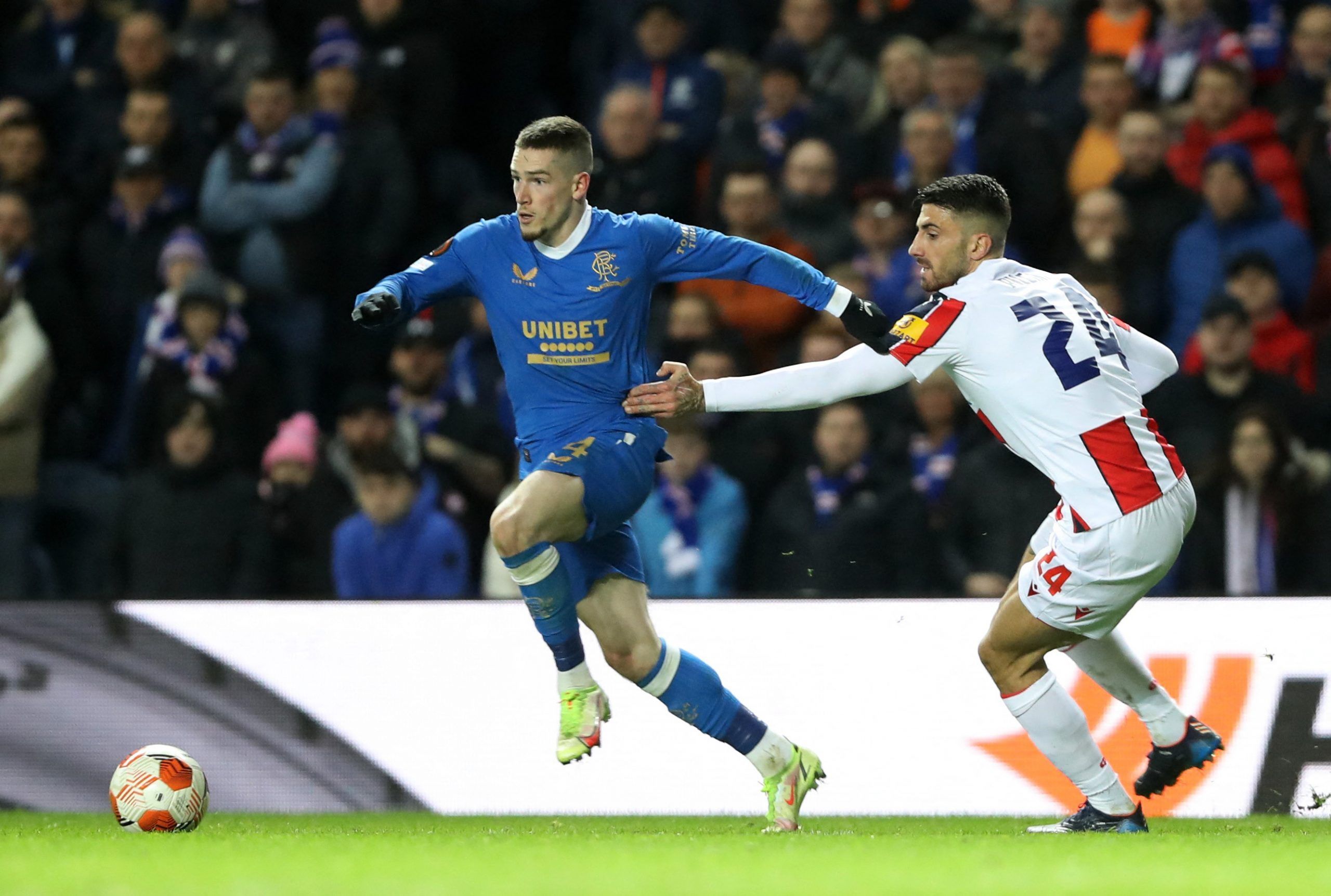 Soccer Football - Europa League - Round of 16 First Leg - Rangers v Crvena Zvezda - Ibrox, Glasgow, Scotland, Britain - March 10, 2022 Rangers' Ryan Kent in action with Crvena Zvezda's Cristiano Piccini REUTERS/Russell Cheyne