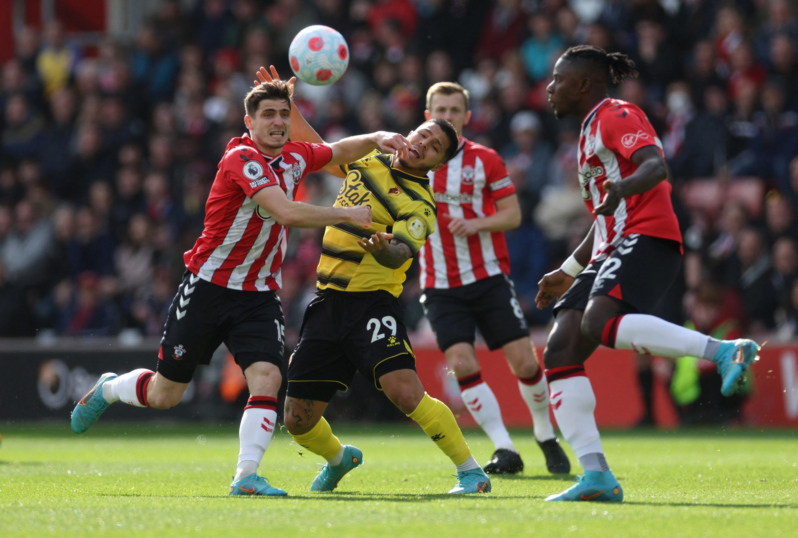 Soccer Football - Premier League - Southampton v Watford - St Mary's Stadium, Southampton, Britain - March 13, 2022 Southampton's Romain Perraud in action with  Watford's Cucho Hernandez Action Images via Reuters/Paul Childs EDITORIAL USE ONLY. No use with unauthorized audio, video, data, fixture lists, club/league logos or 'live' services. Online in-match use limited to 75 images, no video emulation. No use in betting, games or single club /league/player publications.  Please contact your accou