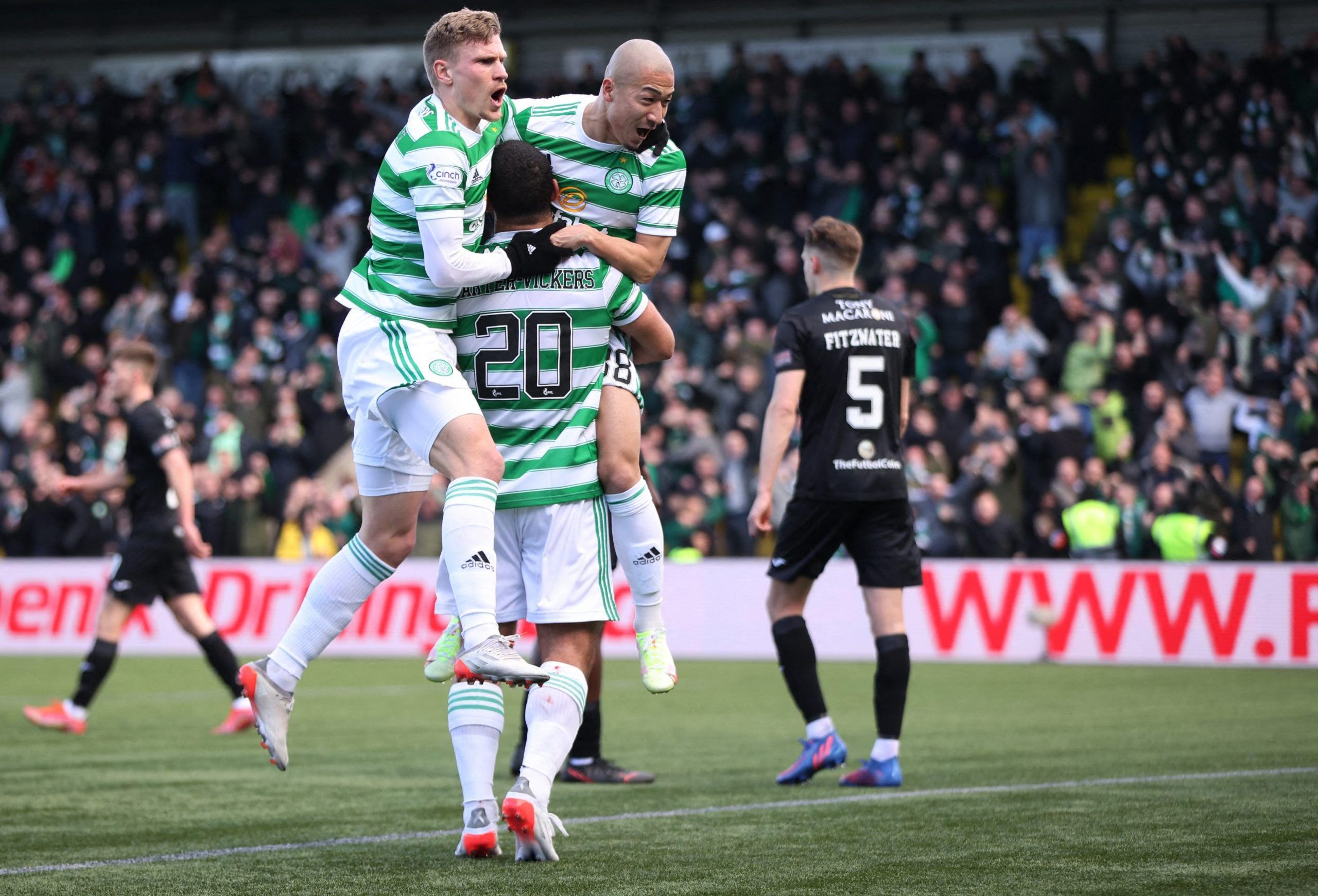 Soccer Football - Scottish Premiership - Livingston v Celtic - Almondvale Stadium, Livingston, Scotland, Britain - March 6, 2022 Celtic's Daizen Maeda celebrates scoring their first goal with Cameron Carter-Vickers and a teammate Action Images via Reuters/Molly Darlington