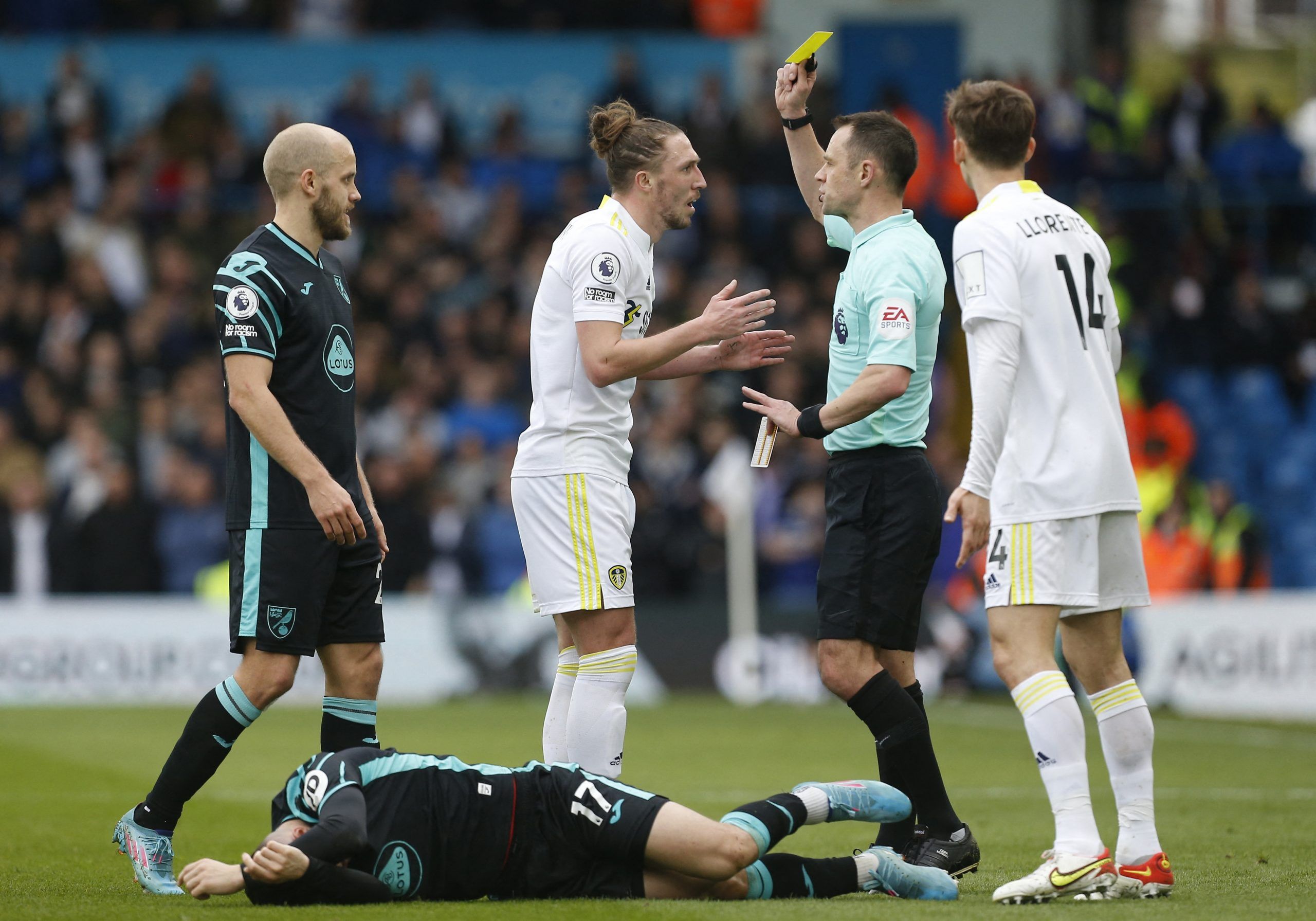 Soccer Football - Premier League - Leeds United v Norwich City - Elland Road, Leeds, Britain - March 13, 2022  Leeds United's Luke Ayling is shown a yellow card by referee Stuart Attwell REUTERS/Craig Brough EDITORIAL USE ONLY. No use with unauthorized audio, video, data, fixture lists, club/league logos or 'live' services. Online in-match use limited to 75 images, no video emulation. No use in betting, games or single club /league/player publications.  Please contact your account representative