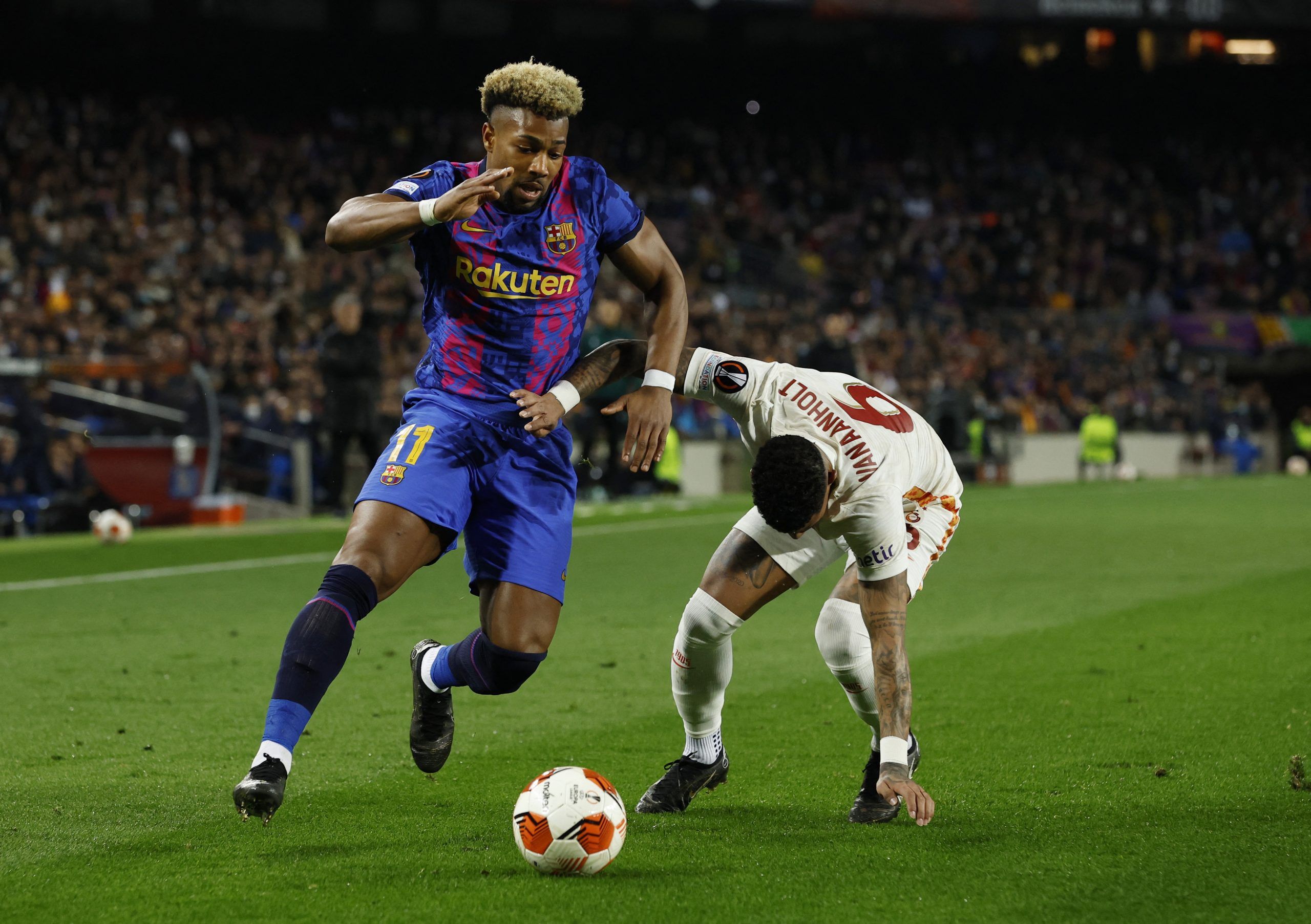 Soccer Football - Europa League - Round of 16 First Leg - FC Barcelona v Galatasaray - Camp Nou, Barcelona, Spain - March 10, 2022 FC Barcelona's Adama Traore in action with Galatasaray's Patrick van Aanholt REUTERS/Albert Gea
