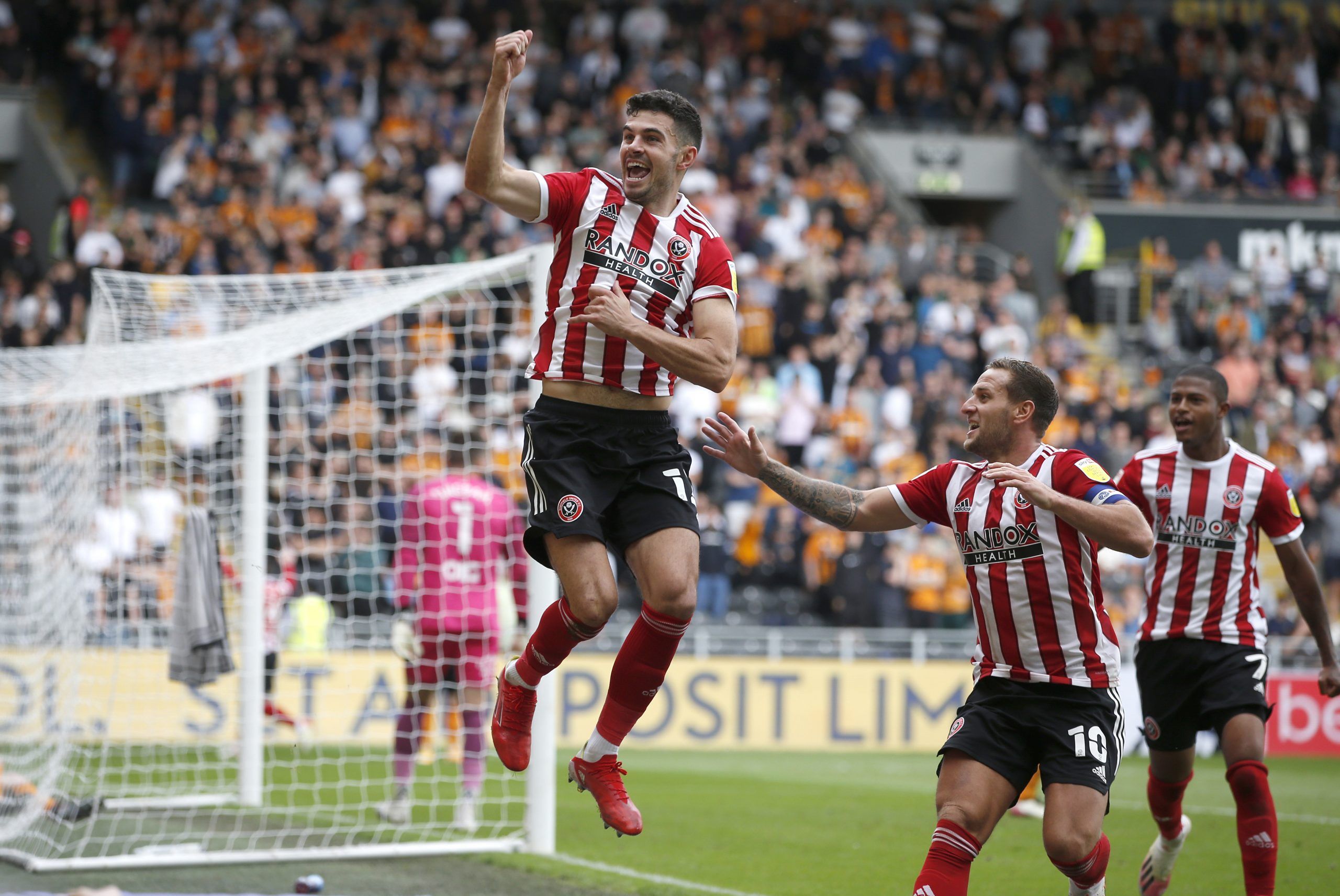 Soccer Football - Championship - Hull City v Sheffield United - KCOM Stadium, Hull, Britain - September 18, 2021 Sheffield United's John Egan celebrates scoring their second goal with teammates Action Images/Ed Sykes EDITORIAL USE ONLY. No use with unauthorized audio, video, data, fixture lists, club/league logos or 'live' services. Online in-match use limited to 75 images, no video emulation. No use in betting, games or single club /league/player publications.  Please contact your account repre