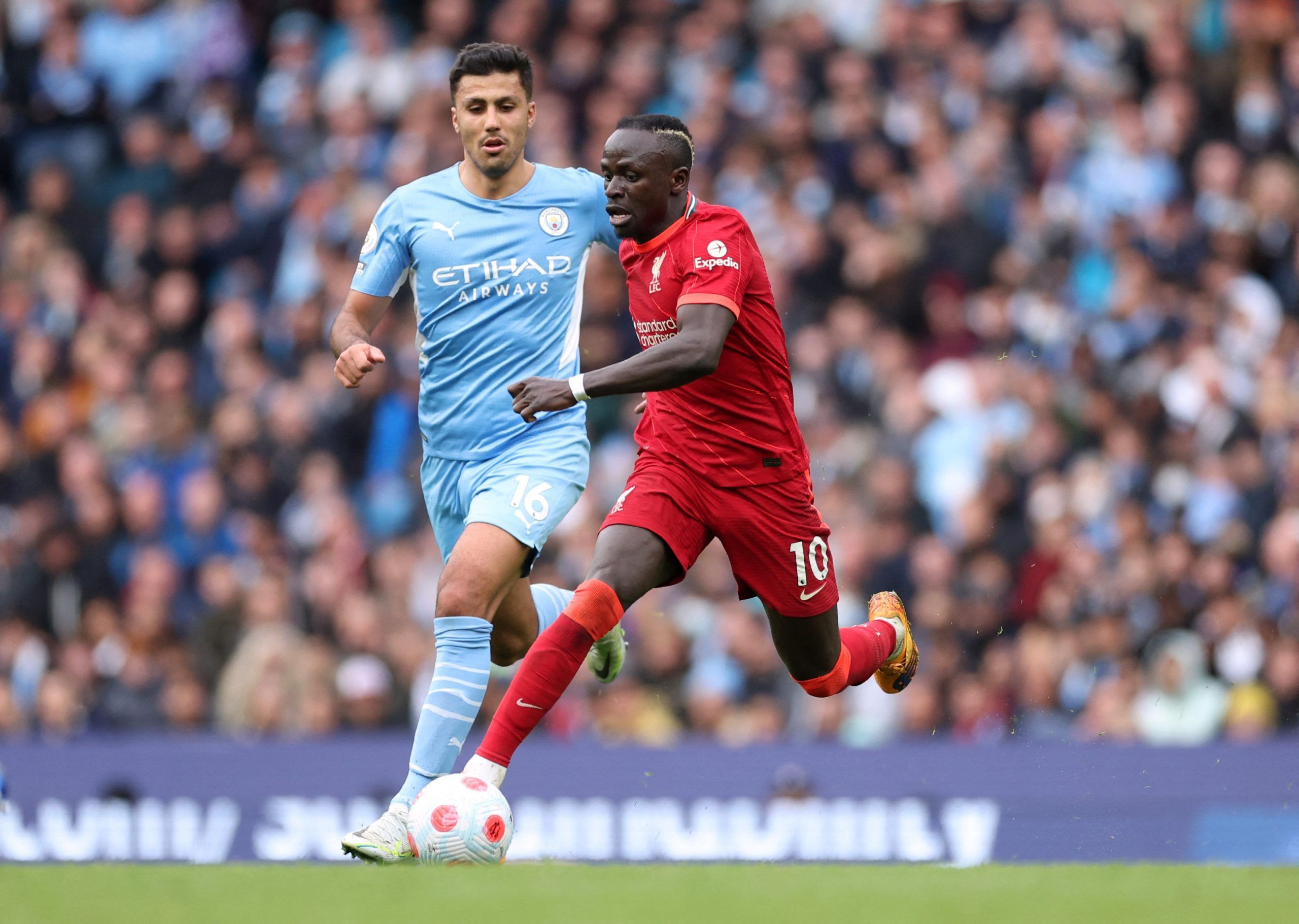 Soccer Football - Premier League - Manchester City v Liverpool - Etihad Stadium, Manchester, Britain - April 10, 2022 Liverpool's Sadio Mane in action with Manchester City's Rodri Action Images via Reuters/Carl Recine EDITORIAL USE ONLY. No use with unauthorized audio, video, data, fixture lists, club/league logos or 'live' services. Online in-match use limited to 75 images, no video emulation. No use in betting, games or single club /league/player publications.  Please contact your account repr
