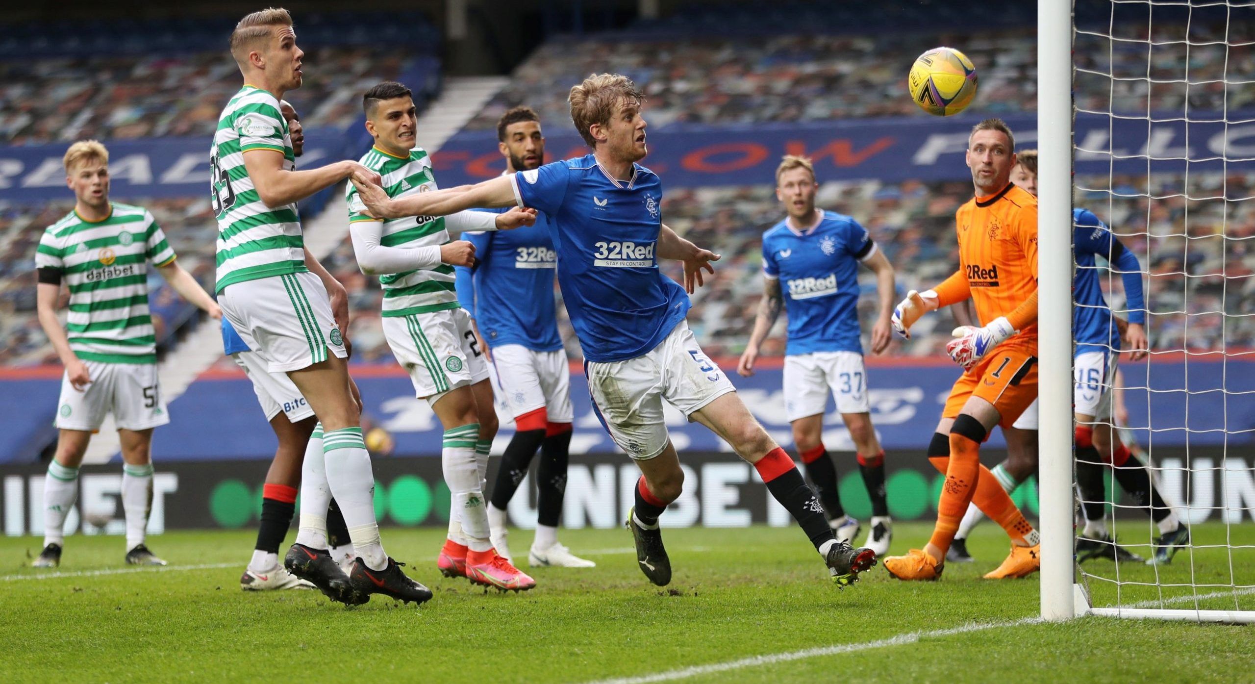 Soccer Football - Scottish Cup Fourth Round - Rangers v Celtic - Ibrox Stadium, Glasgow, Scotland, Britain - April 18, 2021 Celtic's Kristoffer Ajer in action with Rangers' Filip Helander REUTERS/Russell Cheyne REFILE - CORRECTING COMPETITION