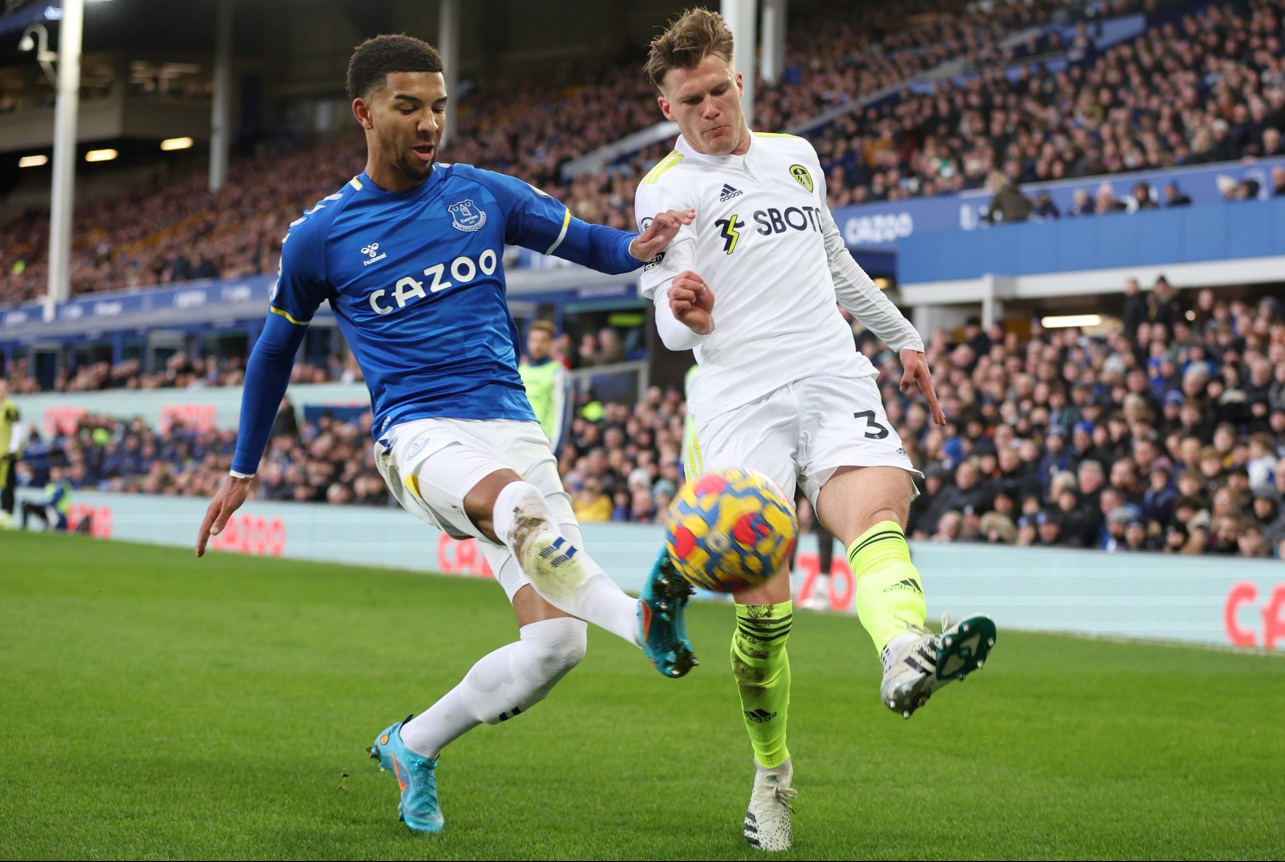 Soccer Football - Premier League - Everton v Leeds United - Goodison Park, Liverpool, Britain - February 12, 2022 Everton's Mason Holgate in action with Leeds United's Leo Fuhr Hjelde Action Images via Reuters/Carl Recine EDITORIAL USE ONLY. No use with unauthorized audio, video, data, fixture lists, club/league logos or 'live' services. Online in-match use limited to 75 images, no video emulation. No use in betting, games or single club /league/player publications.  Please contact your account 