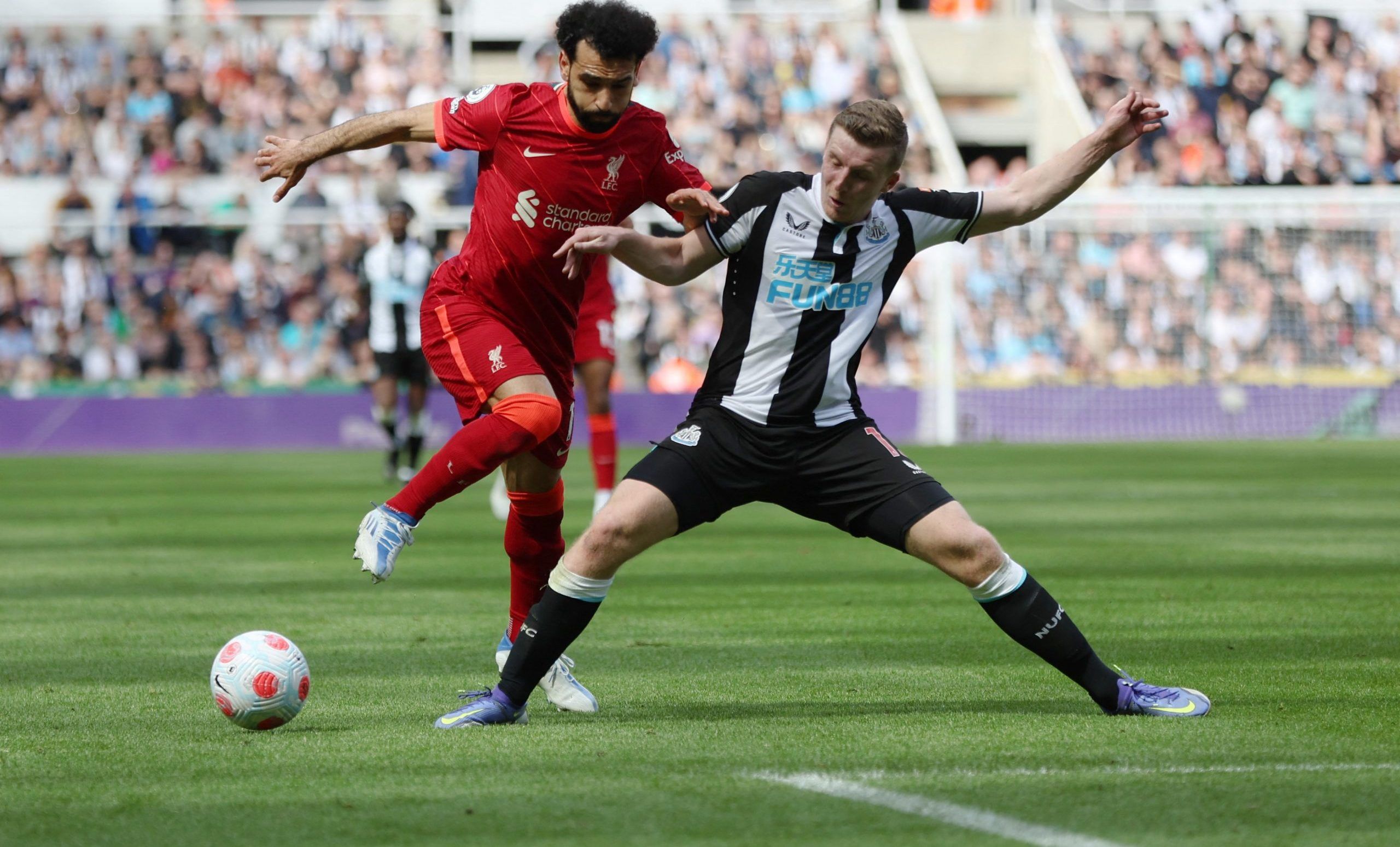 Soccer Football - Premier League - Newcastle United v Liverpool - St James' Park, Newcastle, Britain - April 30, 2022 Liverpool's Mohamed Salah in action with Newcastle United's Matt Targett Action Images via Reuters/Lee Smith EDITORIAL USE ONLY. No use with unauthorized audio, video, data, fixture lists, club/league logos or 'live' services. Online in-match use limited to 75 images, no video emulation. No use in betting, games or single club /league/player publications.  Please contact your acc