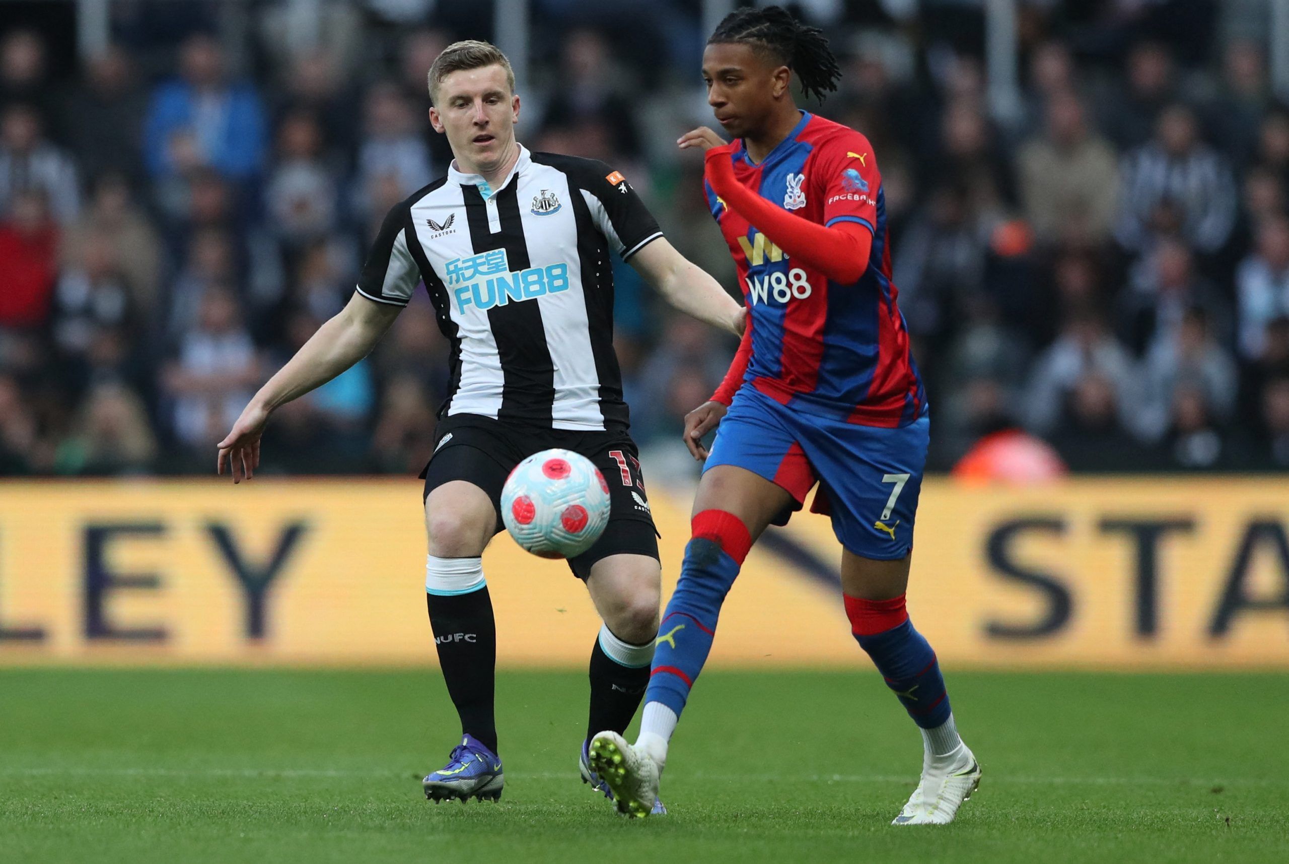 Soccer Football - Premier League - Newcastle United v Crystal Palace - St James' Park, Newcastle, Britain - April 20, 2022  Crystal Palace's Michael Olise in action with Newcastle United's Matt Targett REUTERS/Scott Heppell EDITORIAL USE ONLY. No use with unauthorized audio, video, data, fixture lists, club/league logos or 'live' services. Online in-match use limited to 75 images, no video emulation. No use in betting, games or single club /league/player publications.  Please contact your accoun