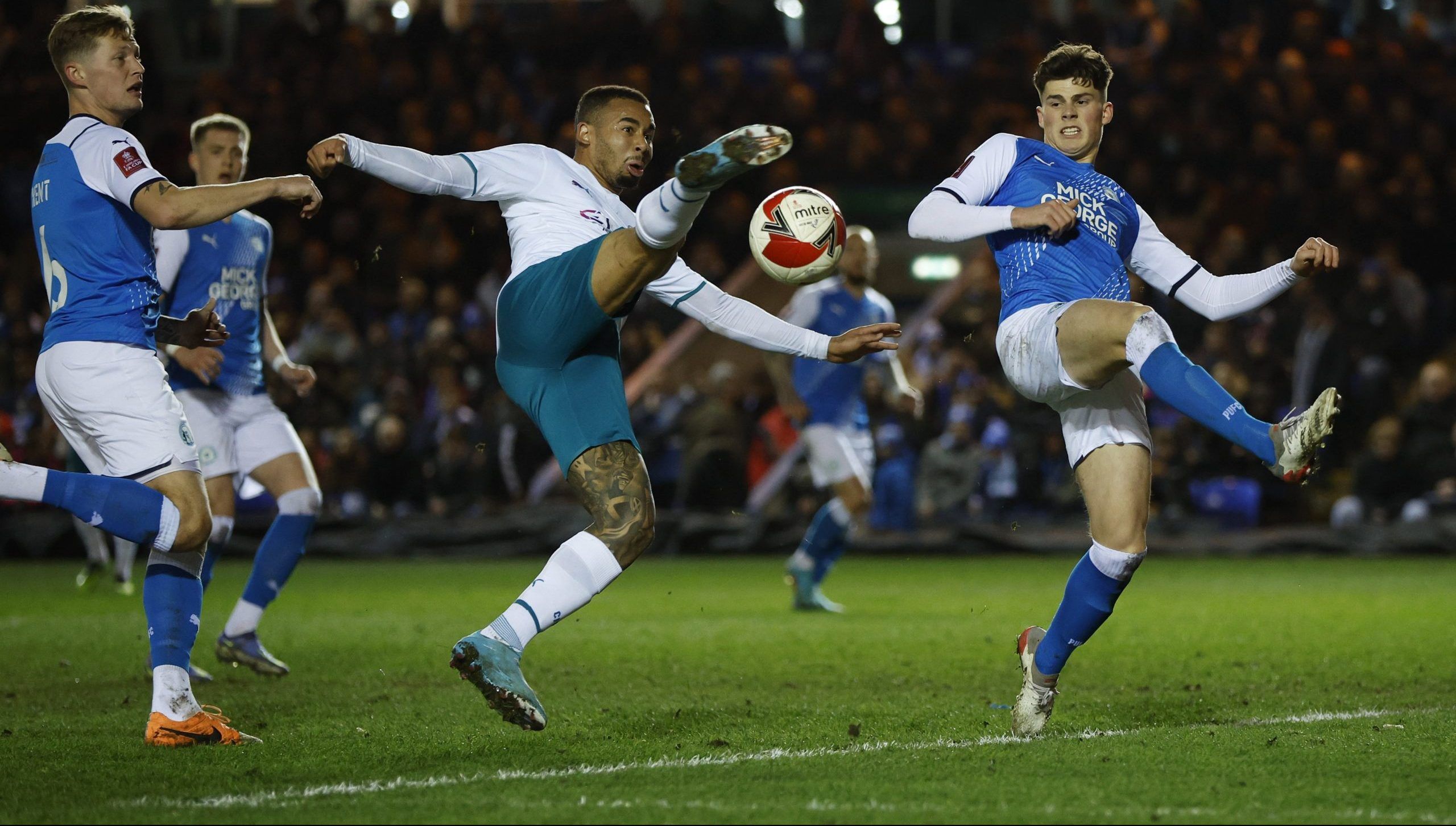 Soccer Football - FA Cup Fifth Round - Peterborough United v Manchester City - Weston Homes Stadium, Peterborough, Britain - March 1, 2022 Manchester City's Gabriel Jesus in action with Peterborough United's Ronnie Edwards Action Images via Reuters/John Sibley