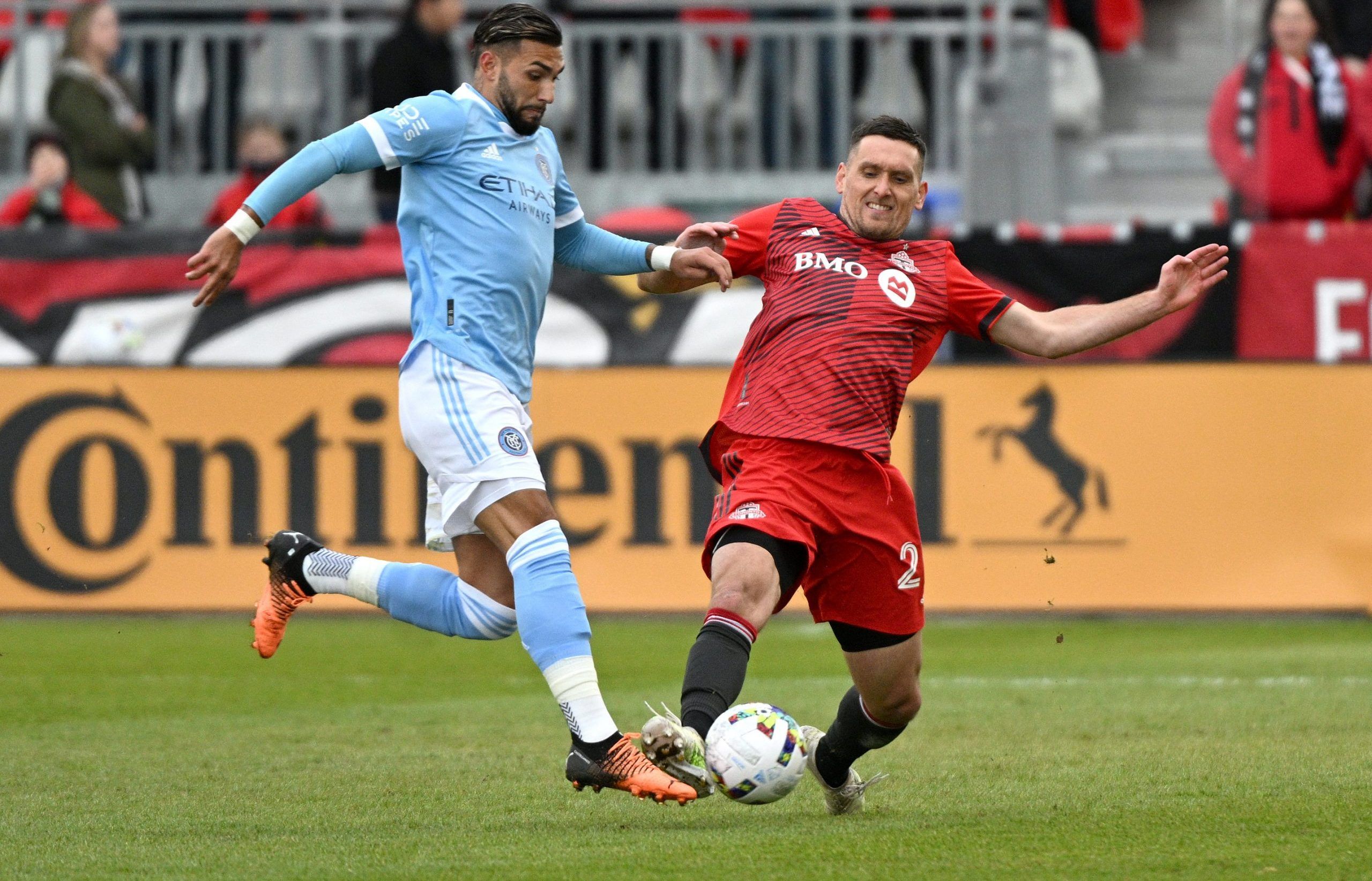 Apr 2, 2022; Toronto, Ontario, CAN;   Toronto FC defender Shane O'Neill (27) battles for the ball with New York City FC forward Valentin Castellanos (11) in the first half at BMO Field. Mandatory Credit: Dan Hamilton-USA TODAY Sports