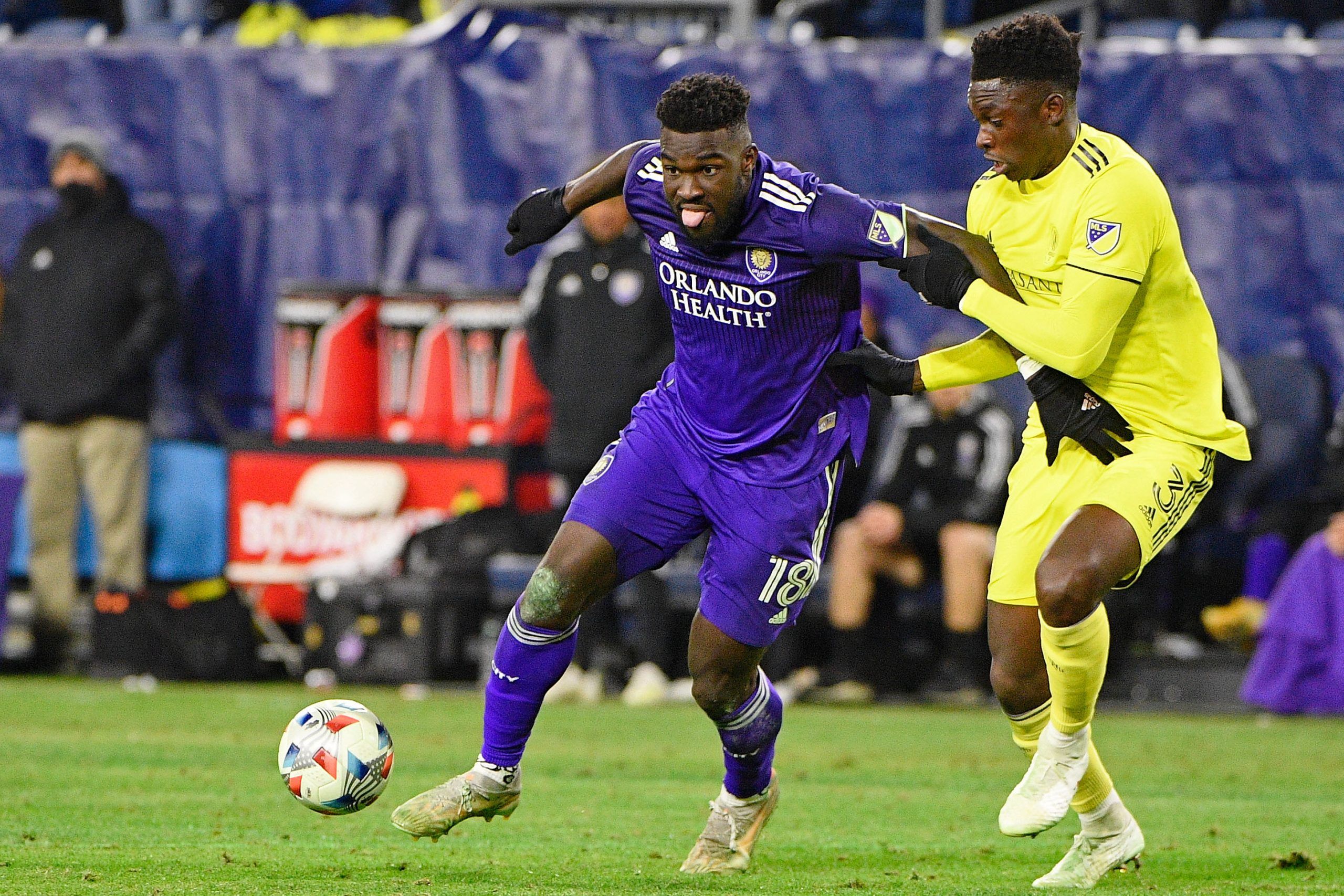 Nov 23, 2021; Nashville, TN, USA; Orlando City forward Daryl Dike (18) battles for the ball with Nashville SC defender Jalil Anibaba (3) during the second half of a round one MLS Playoff game at Nissan Stadium. Mandatory Credit: Steve Roberts-USA TODAY Sports