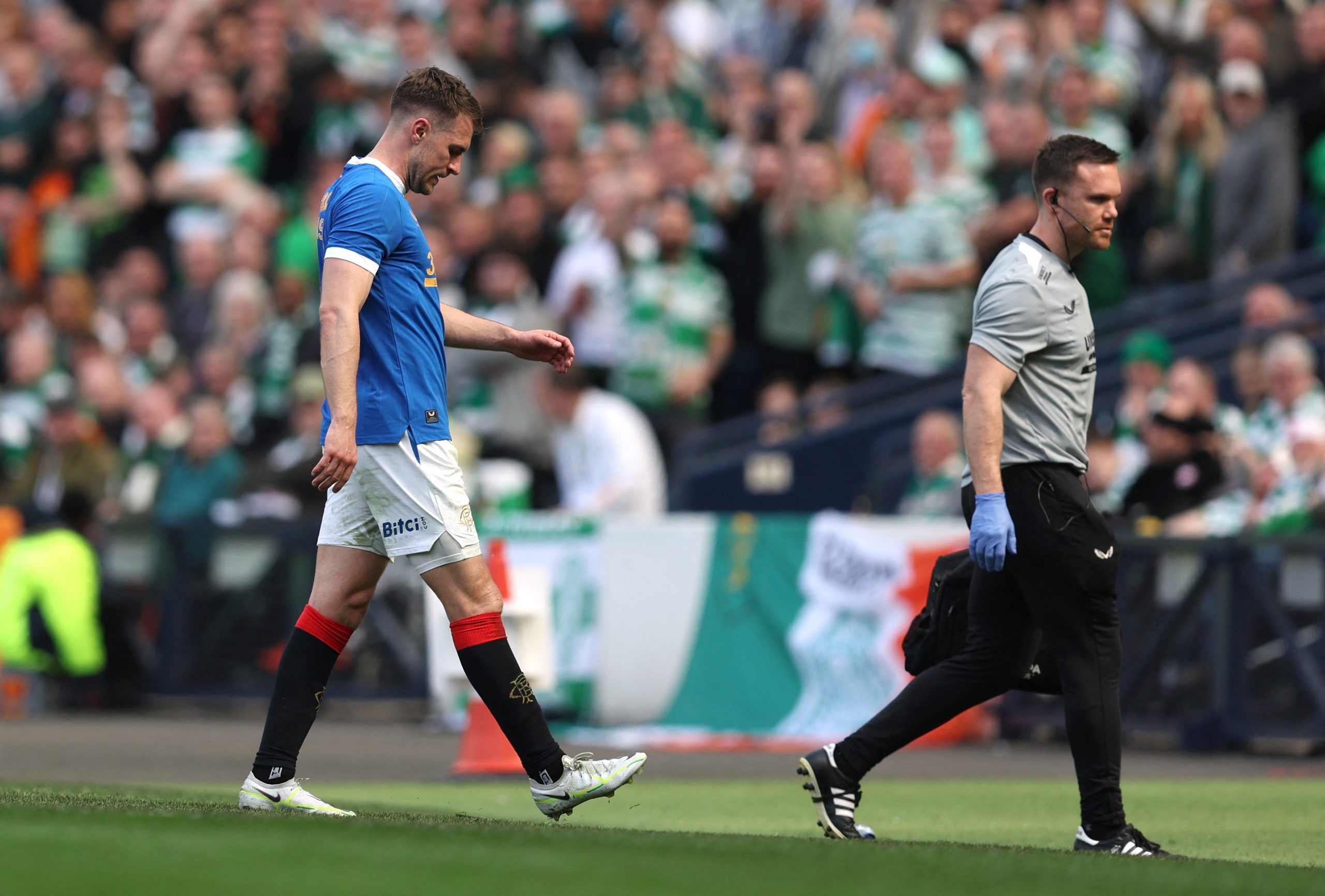 Soccer Football - Scottish Cup Semi Final - Celtic v Rangers - Hampden Park, Glasgow, Scotland, Britain - April 17, 2022 Rangers' Aaron Ramsey receives medical attention after sustaining an injury REUTERS/Russell Cheyne