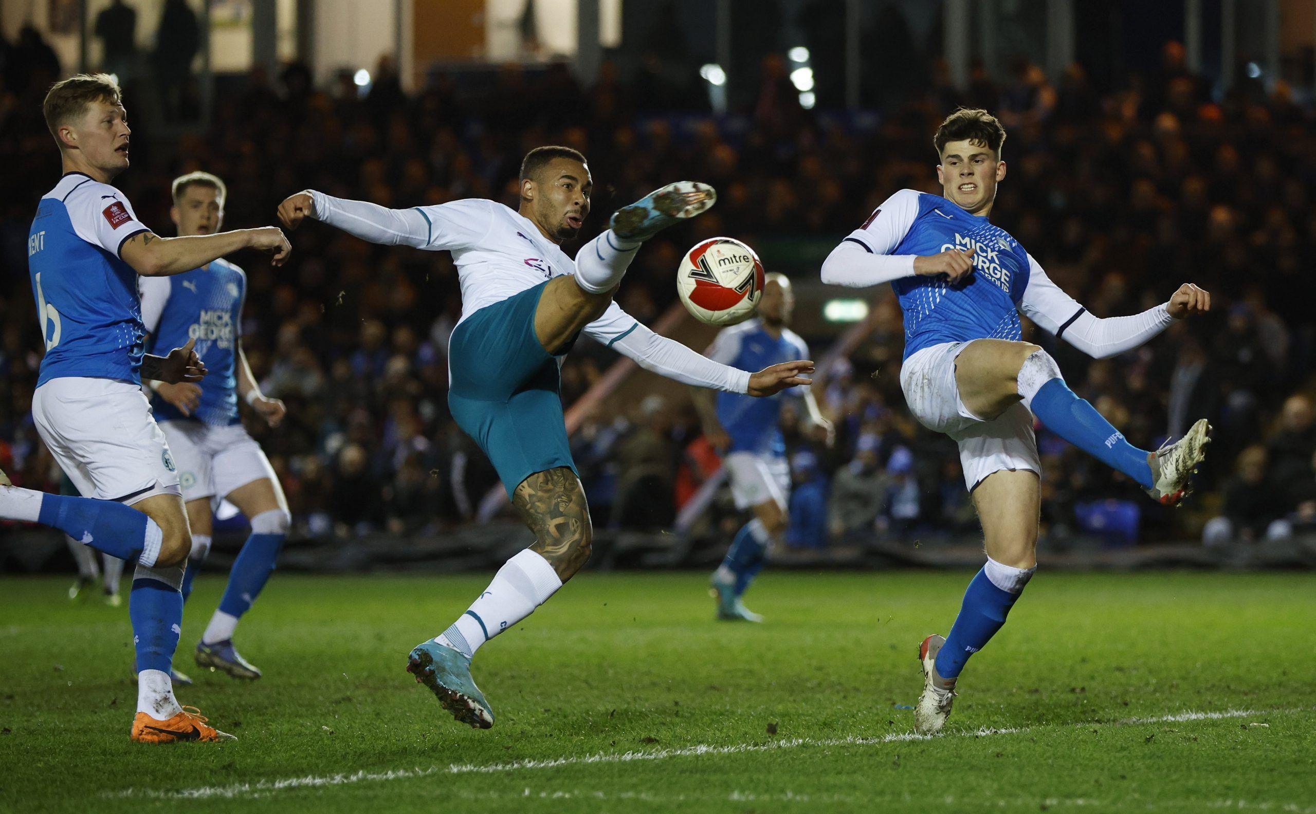 Soccer Football - FA Cup Fifth Round - Peterborough United v Manchester City - Weston Homes Stadium, Peterborough, Britain - March 1, 2022 Manchester City's Gabriel Jesus in action with Peterborough United's Ronnie Edwards Action Images via Reuters/John Sibley