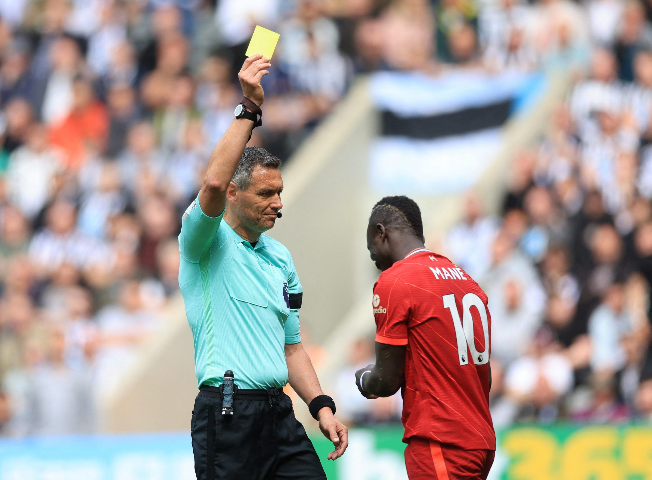 Soccer Football - Premier League - Newcastle United v Liverpool - St James' Park, Newcastle, Britain - April 30, 2022 Liverpool's Sadio Mane is shown a yellow card by referee Andre Marriner Action Images via Reuters/Lee Smith EDITORIAL USE ONLY. No use with unauthorized audio, video, data, fixture lists, club/league logos or 'live' services. Online in-match use limited to 75 images, no video emulation. No use in betting, games or single club /league/player publications.  Please contact your acco