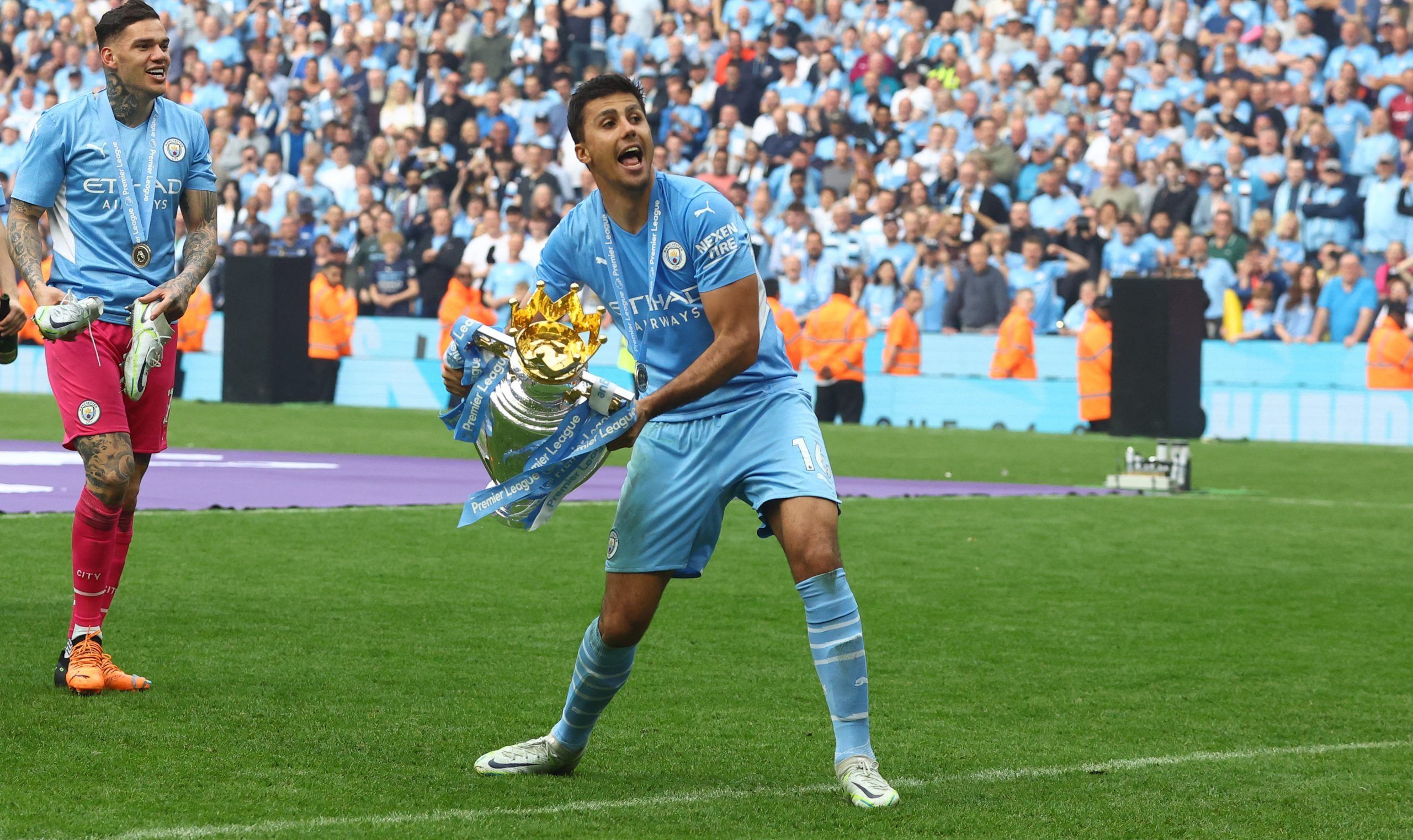 Soccer Football - Premier League - Manchester City v Aston Villa - Etihad Stadium, Manchester, Britain - May 22, 2022 Manchester City's Rodri celebrates with the trophy after winning the Premier League REUTERS/Hannah Mckay EDITORIAL USE ONLY. No use with unauthorized audio, video, data, fixture lists, club/league logos or 'live' services. Online in-match use limited to 75 images, no video emulation. No use in betting, games or single club /league/player publications.  Please contact your account