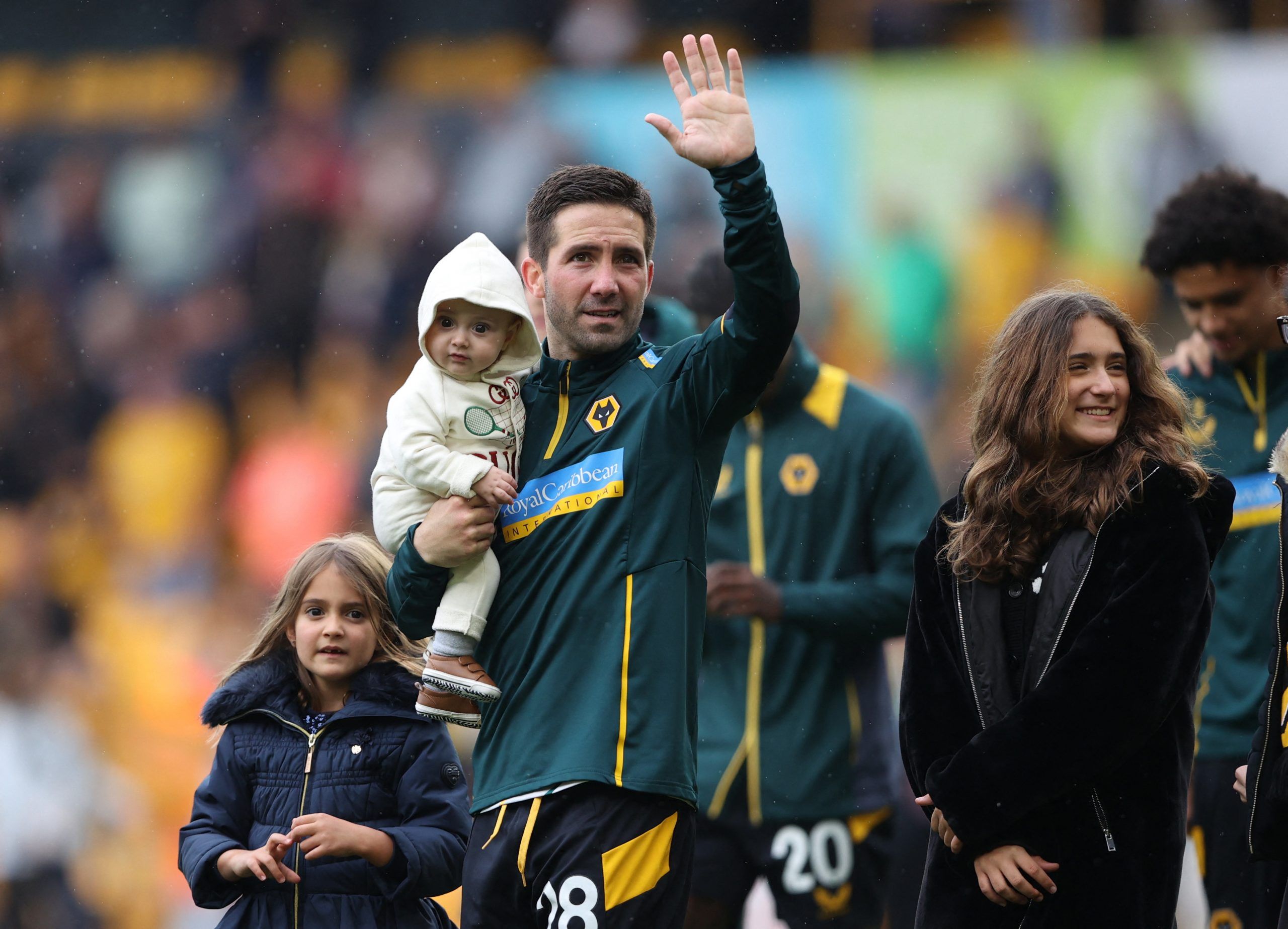 Soccer Football - Premier League - Wolverhampton Wanderers v Norwich City - Molineux Stadium, Wolverhampton, Britain - May 15, 2022 Wolverhampton Wanderers' Joao Moutinho with family on the pitch after the match Action Images via Reuters/Molly Darlington EDITORIAL USE ONLY. No use with unauthorized audio, video, data, fixture lists, club/league logos or 'live' services. Online in-match use limited to 75 images, no video emulation. No use in betting, games or single club /league/player publicatio