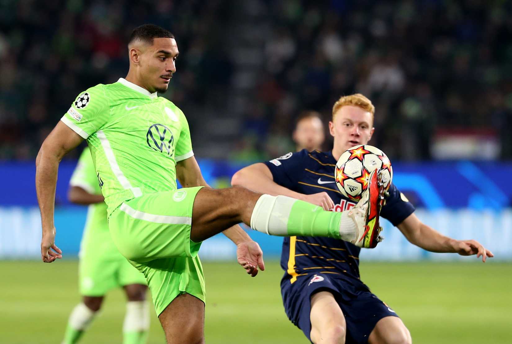 Soccer Football - Champions League - Group G - VfL Wolfsburg v FC Salzburg - Volkswagen Arena, Wolfsburg, Germany - November 2, 2021 VfL Wolfsburg's Maxence Lacroix in action with FC Salzburg's Nicolas Seiwald REUTERS/Cathrin Mueller